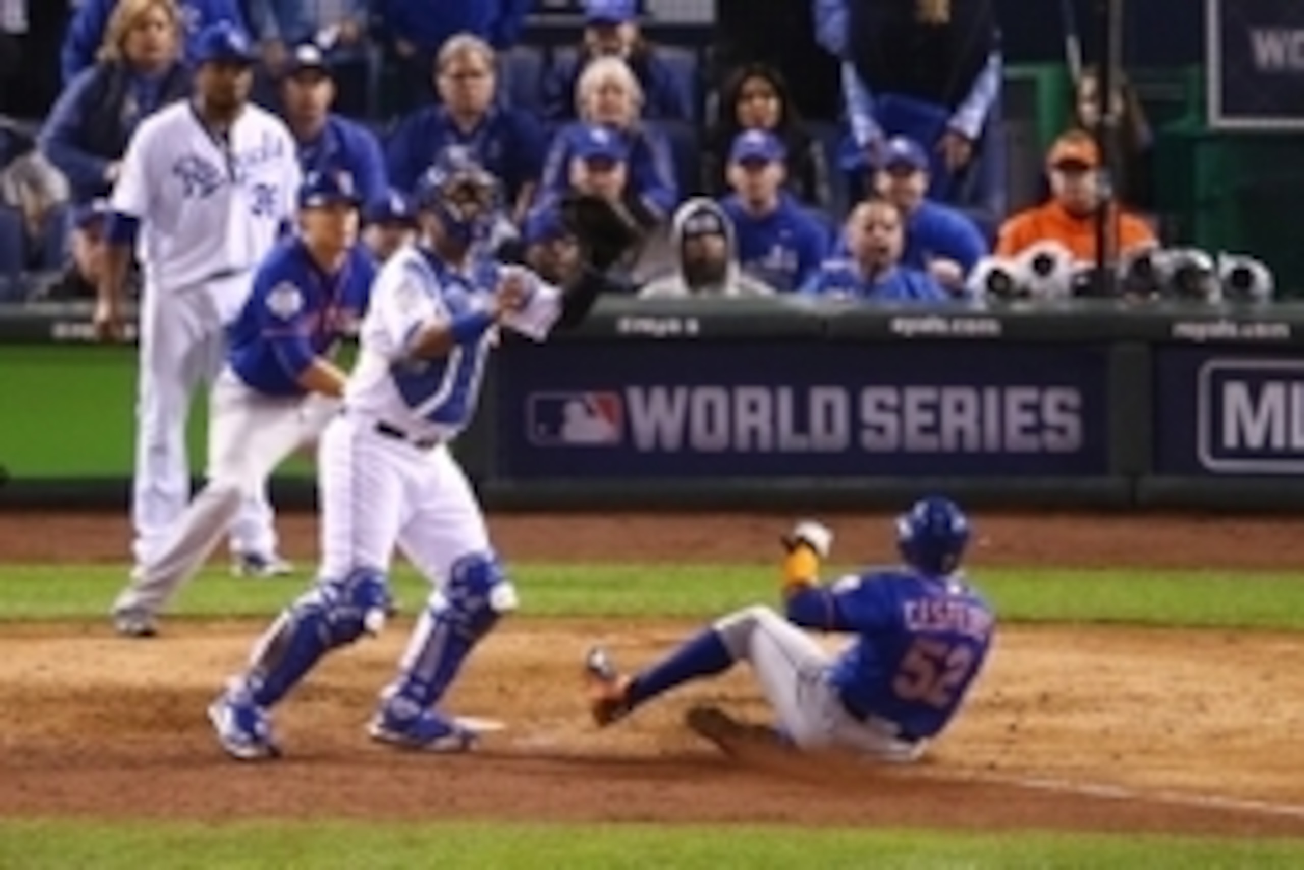 Oct 27, 2015; Kansas City, MO, USA; New York Mets center fielder Yoenis Cespedes (52) scores a run past Kansas City Royals catcher Salvador Perez in the 6th inning in game one of the 2015 World Series at Kauffman Stadium. Mandatory Credit: Peter G. Aiken-