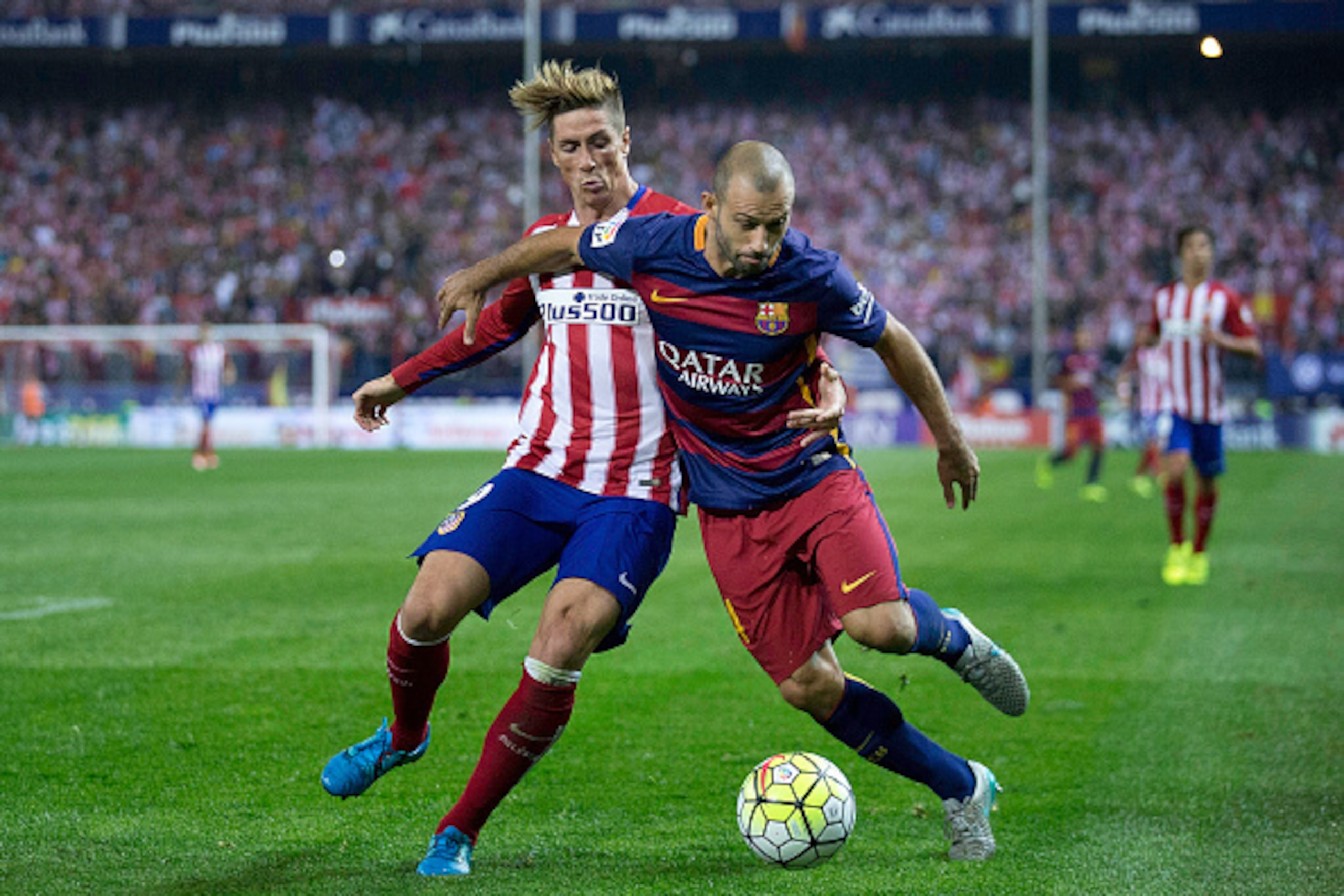 MADRID, SPAIN - SEPTEMBER 12: Fernando Torres (L) of Atletico de Madrid competes for the ball with Javier Alejandro Mascherano (R) of FC Barcelona during the La Liga match between Club Atletico de Madrid and FC Barcelona at Vicente Calderon Stadium on Sep MADRID, SPAIN - SEPTEMBER 12: Fernando Torres (L) of Atletico de Madrid competes for the ball with Javier Alejandro Mascherano (R) of FC Barcelona during the La Liga match between Club Atletico de Madrid and FC Barcelona at Vicente Calderon Stadium on Sep