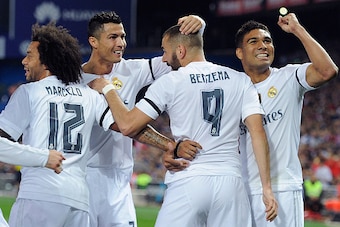 MADRID, SPAIN - OCTOBER 04:  Karim Benzema of Real Madrid celebrates with Cristiano Ronaldo after scoring Real's opening goal during the La Liga match between Club Atletico de Madrid and Real Madrid at Vicente Calderon Stadium on October 4, 2015 in Madrid