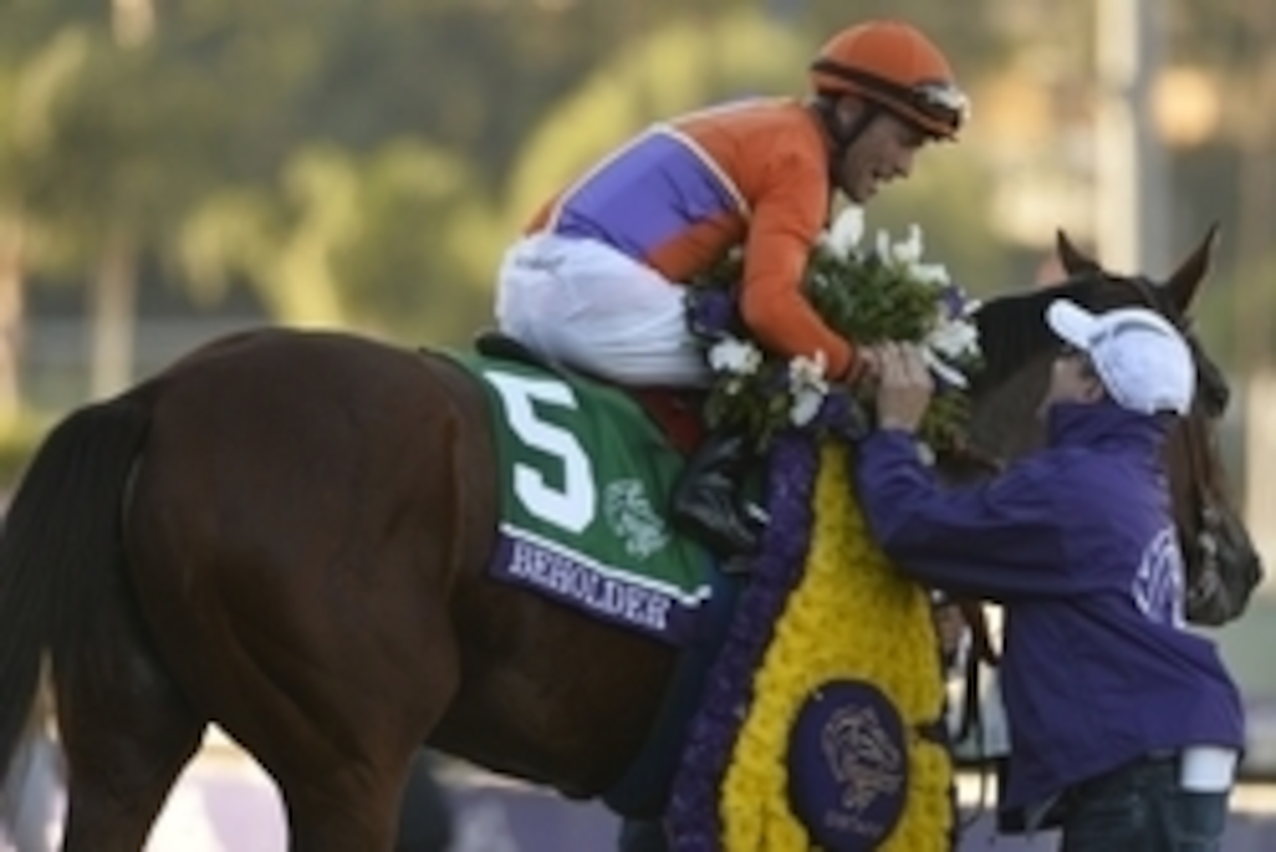 Nov 1, 2013; Arcadia, CA, USA; Gary Stevens aboard Beholder celebrates following victory of race ten during the 2013 Breeders' Cup Championships at Santa Anita Park.  Mandatory Credit: Robert Hanashiro-USA TODAY Sports