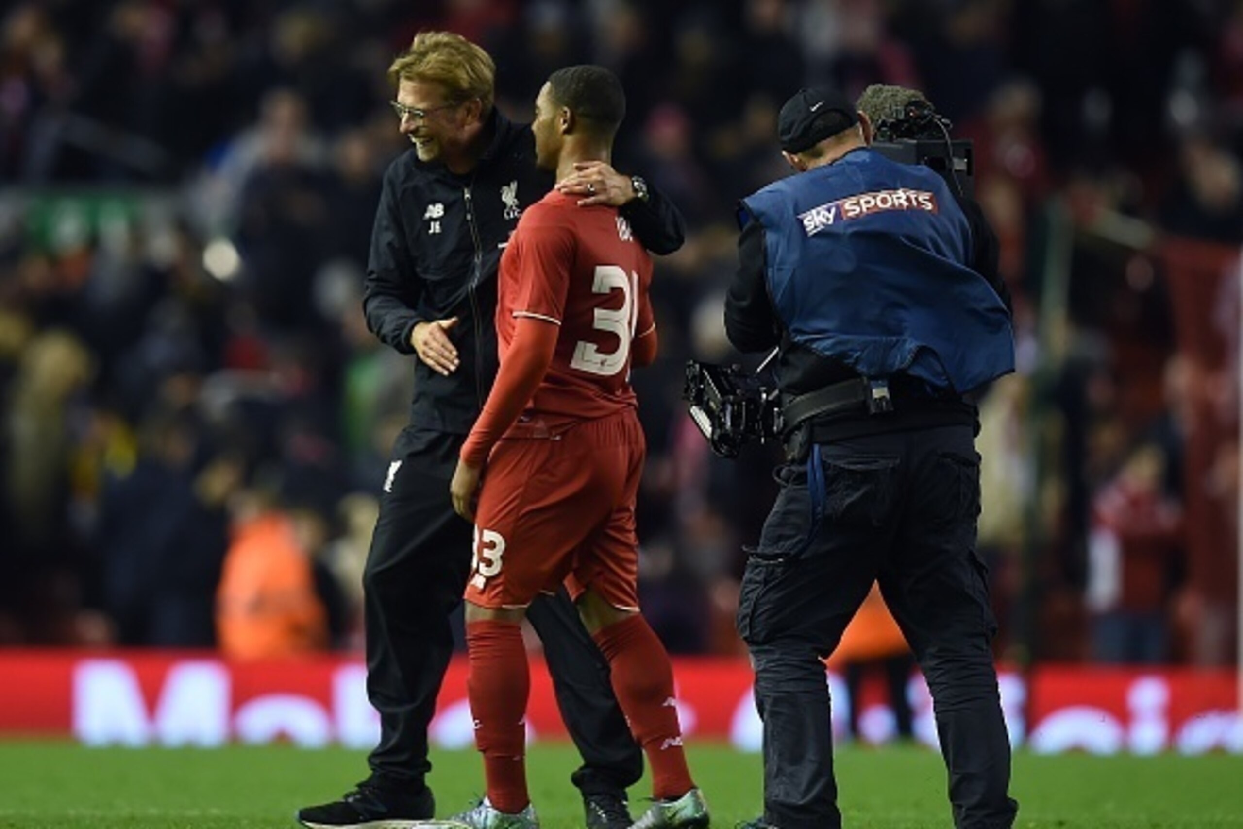 A television camera operator for European pay-TV broadcaster Sky's Sky Sports channel, (R) films Liverpool's German manager Jurgen Klopp (L) reacting with Liverpool's English midfielder Jordon Ibe following the English League Cup fourth round football mat