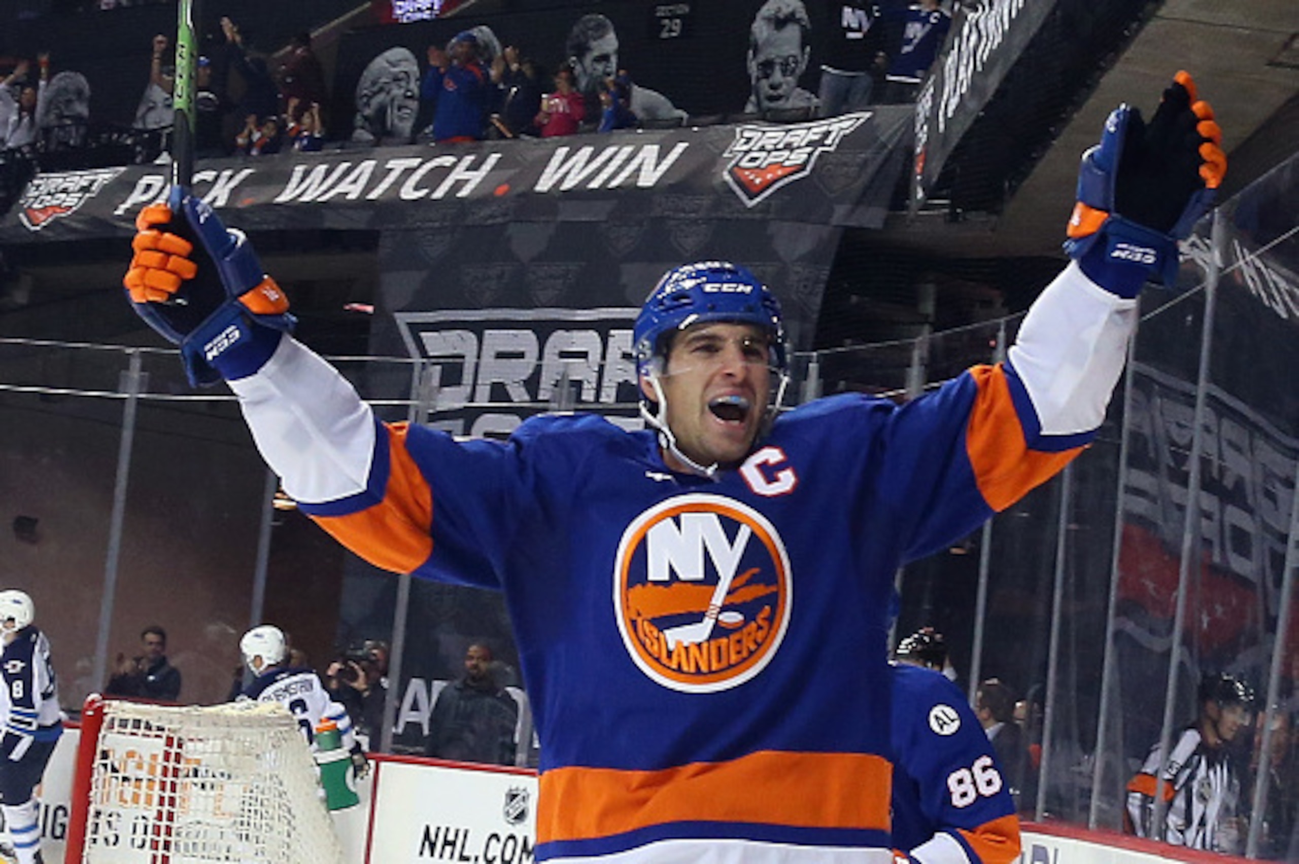 NEW YORK, NY - OCTOBER 12:  John Tavares #91 of the New York Islanders celebrates a second period goal by Brock Nelson #29 against the Winnipeg Jets at the Barclays Center on October 12, 2015 in the Brooklyn borough of New York City.  (Photo by Bruce Benn