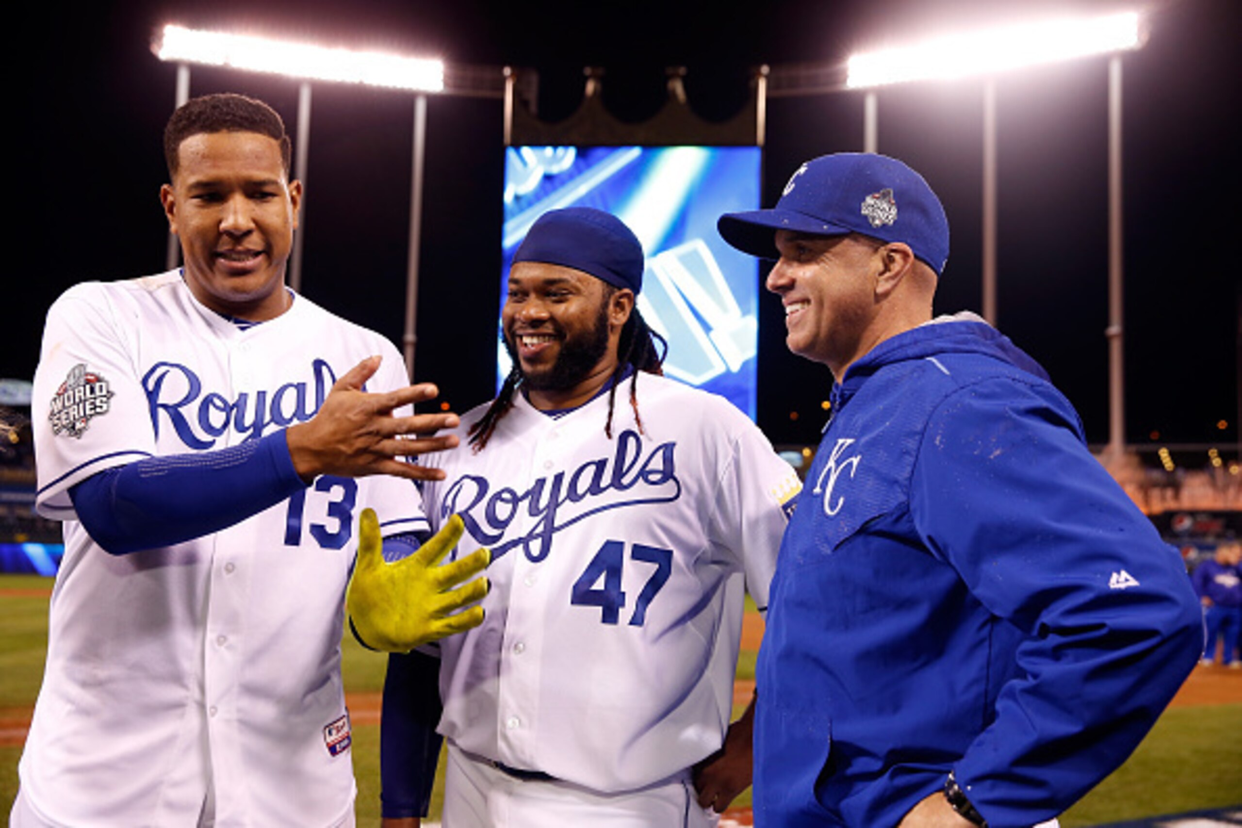 KANSAS CITY, MO - OCTOBER 28: (L-R) Salvador Perez #13 of the Kansas City Royals, Johnny Cueto #47 of the Kansas City Royals, and Pedro Grifol #28 of the Kansas City Royals react after the Kansas City Royals defeat the New York Mets 7-1 in Game Two of th KANSAS CITY, MO - OCTOBER 28: (L-R) Salvador Perez #13 of the Kansas City Royals, Johnny Cueto #47 of the Kansas City Royals, and Pedro Grifol #28 of the Kansas City Royals react after the Kansas City Royals defeat the New York Mets 7-1 in Game Two of th