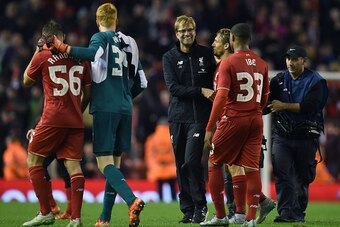 Liverpool's German manager Jurgen Klopp (C) shares a moment with Liverpool's Brazilian midfielder Lucas Leiva (3R) and Liverpool's English midfielder Jordon Ibe (2R) following the English League Cup fourth round football match between Liverpool and Bourne