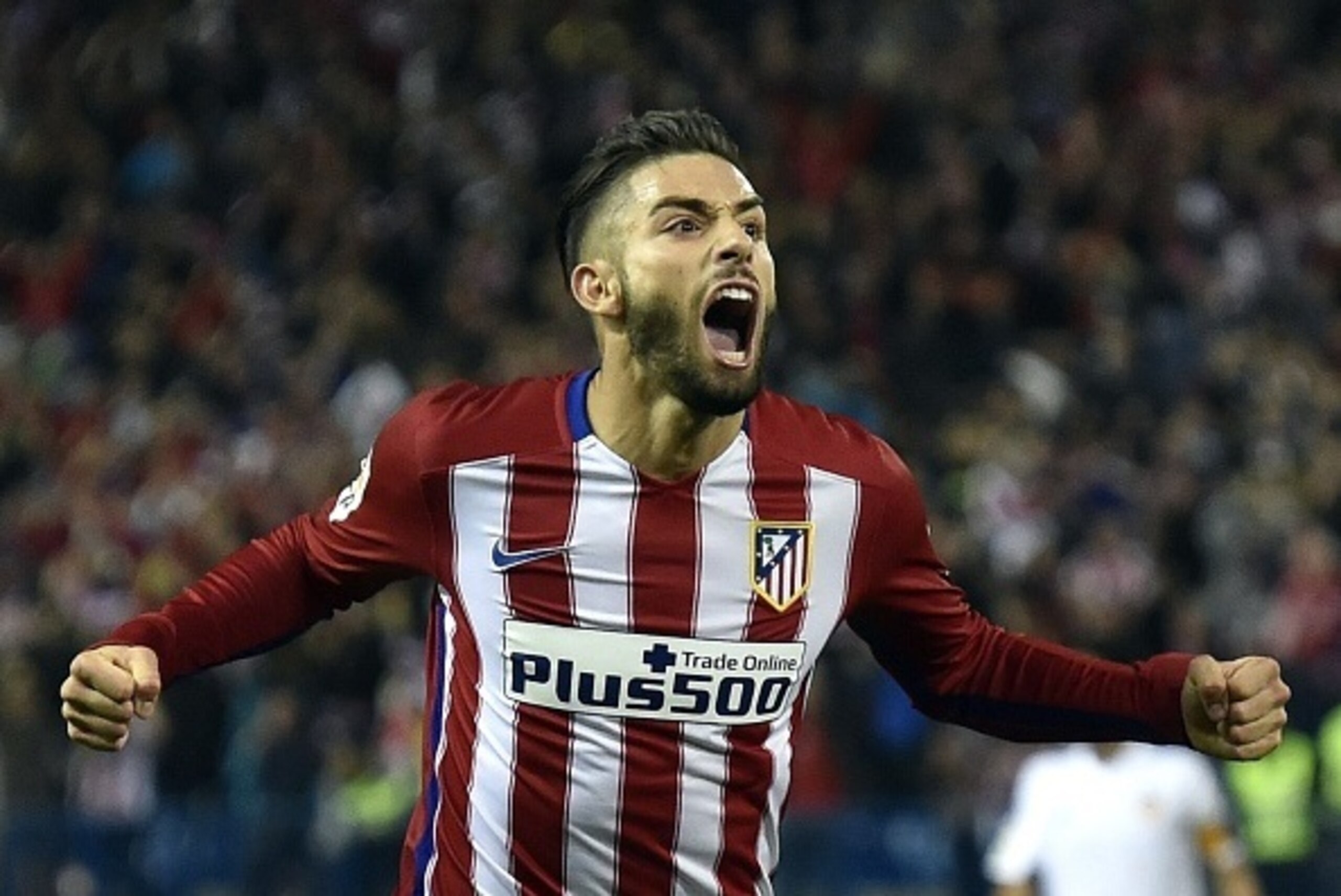 Atletico Madrid's Belgian midfielder Yannick Ferreira Carrasco celebrates a goal during the Spanish league football match Club Atletico de Madrid vs Valencia CF at the Vicente Calderon stadium in Madrid on October 25, 2015.   AFP PHOTO/ GERARD JULIEN     