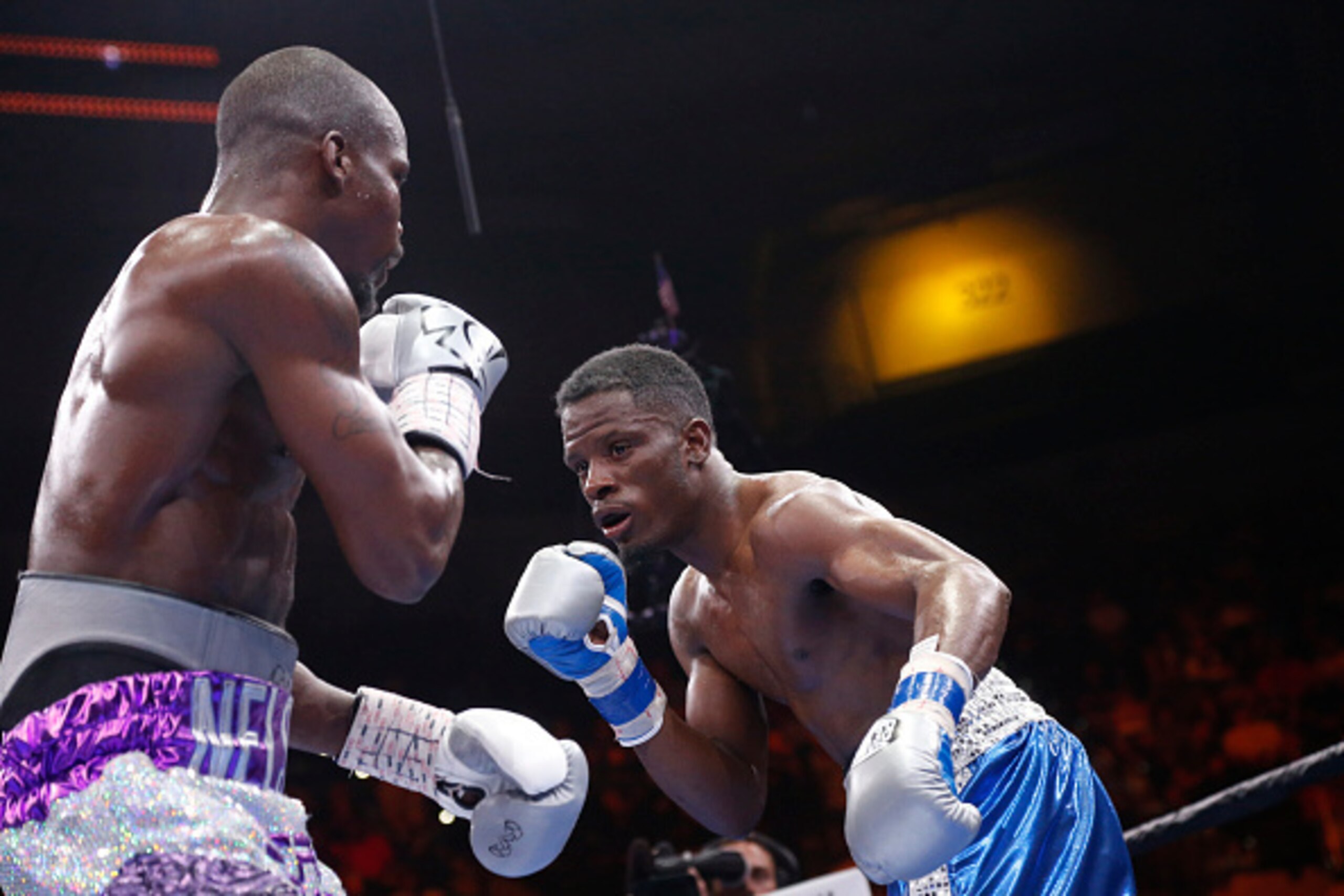 TAMPA, FL - JULY 11:  Willie Nelson (L) exchanges blows with Tony Harrison during their middleweight fight on July 11, 2015 at the USF Sun Dome in Tampa, Florida.  (Photo by Brian Blanco/Getty Images)