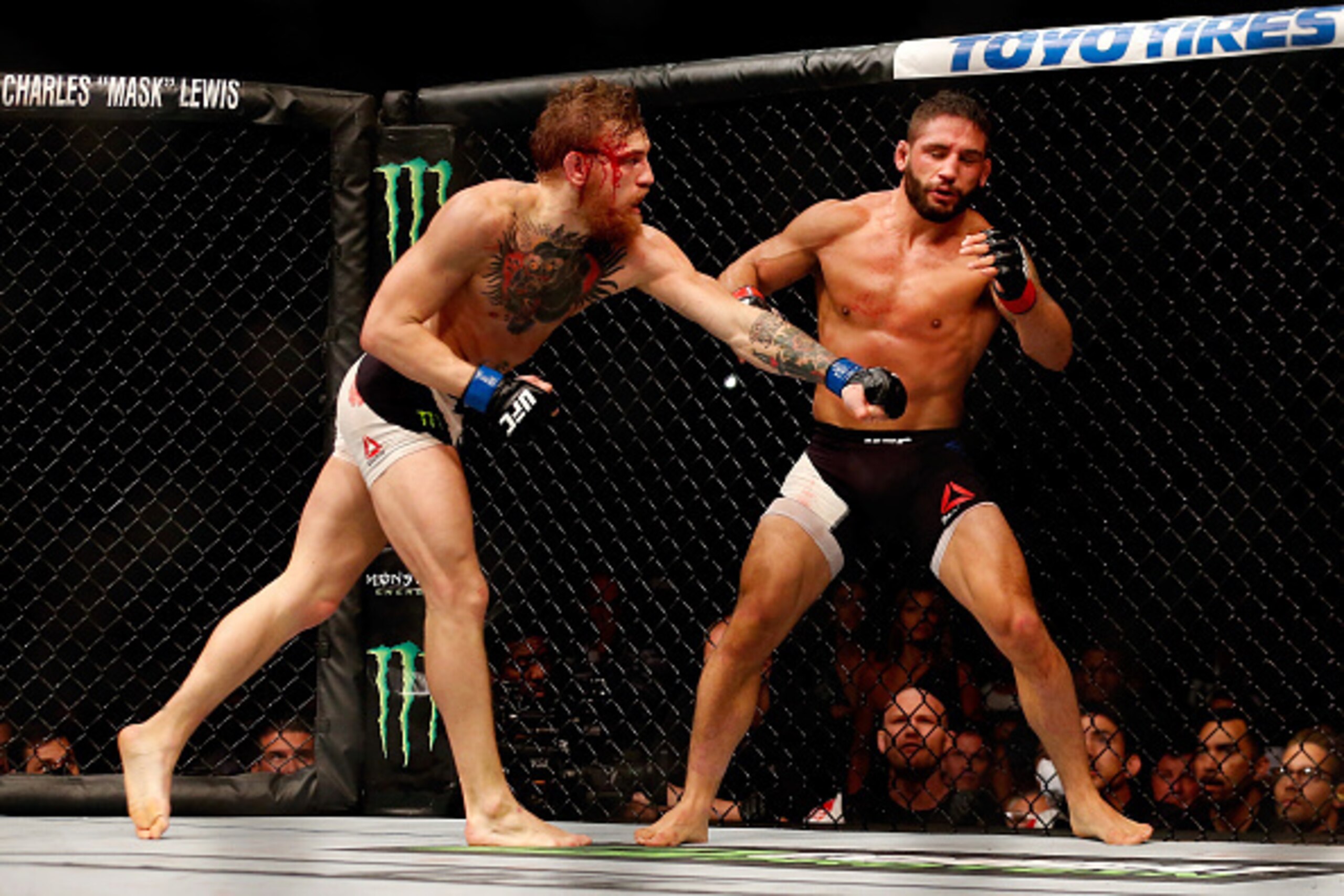 LAS VEGAS, NV - JULY 11:  (L-R) Conor McGregor punches Chad Mendes in their UFC interim featherweight title fight during the UFC 189 event inside MGM Grand Garden Arena on July 11, 2015 in Las Vegas, Nevada.  (Photo by Christian Petersen/Zuffa LLC/Zuffa L