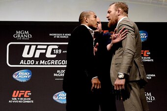 RIO DE JANEIRO, BRAZIL - MARCH 20:  UFC Featherweight Champion Jose Aldo of Brazil (L) and challenger Conor McGregor of Ireland face off as UFC President Dana White (C) stands in during the 189 World Media Tour Launch press conference at Maracanazinho on 