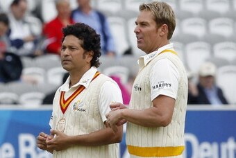 Former Indian international cricketer and captain of the Marylebone Cricket Club (MCC) team Sachin Tendulkar (L) awaits the start of the game with former Australian international cricketer and captain of the Rest of the World Team Shane Warne at the Lord'