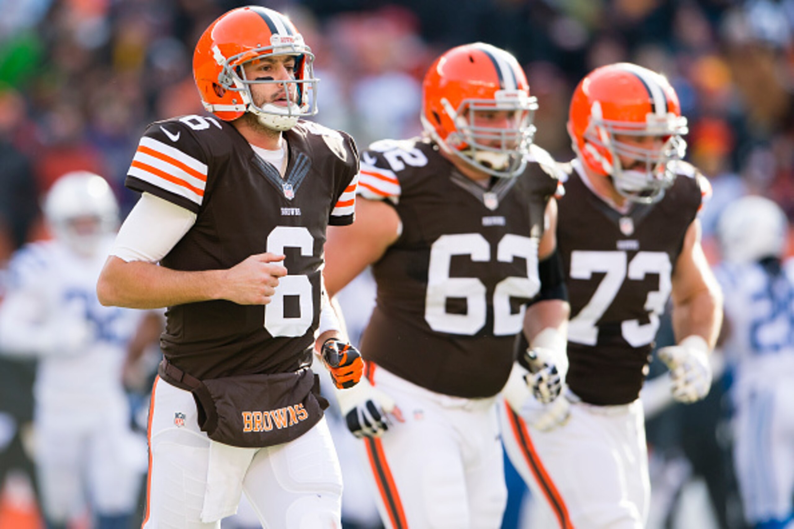CLEVELAND, OH - DECEMBER 07: Quarterback Brian Hoyer #6 tackle Michael Bowie #62 and tackle Joe Thomas #73 of the Cleveland Browns run on the field during the first half against the Indianapolis Colts at FirstEnergy Stadium on December 7, 2014 in Clevelan