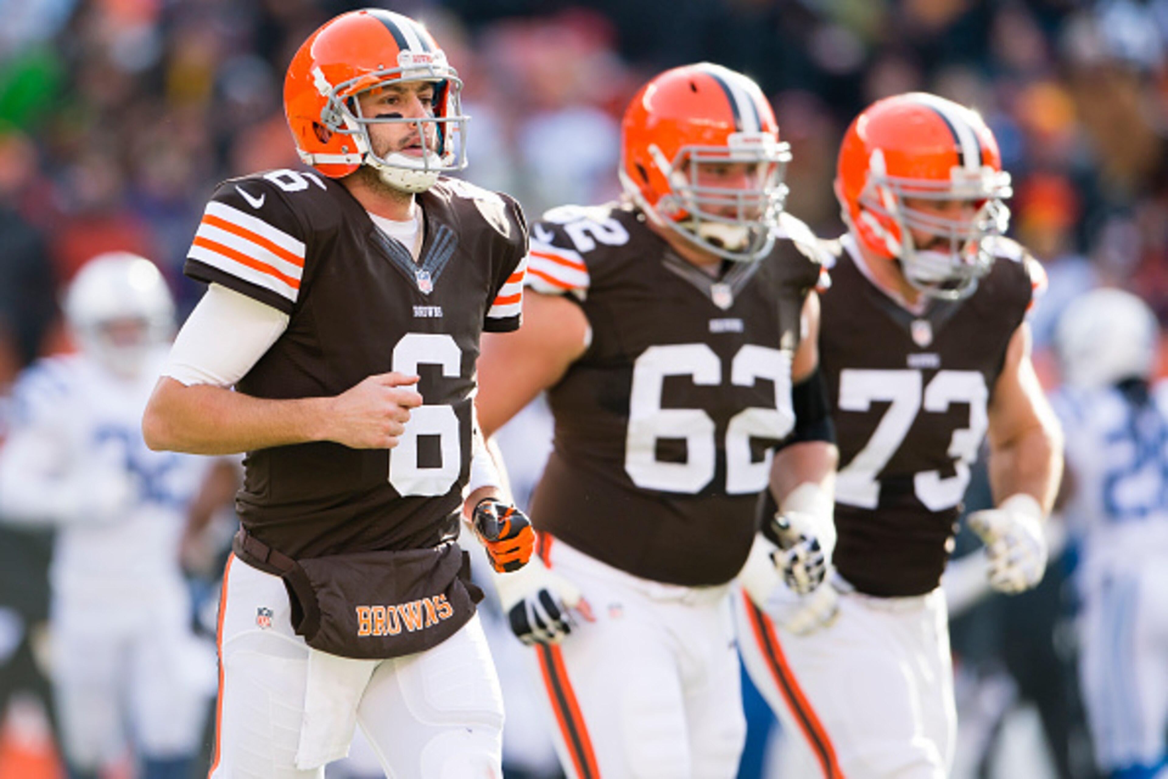 CLEVELAND, OH - DECEMBER 07: Quarterback Brian Hoyer #6 tackle Michael Bowie #62 and tackle Joe Thomas #73 of the Cleveland Browns run on the field during the first half against the Indianapolis Colts at FirstEnergy Stadium on December 7, 2014 in Clevelan