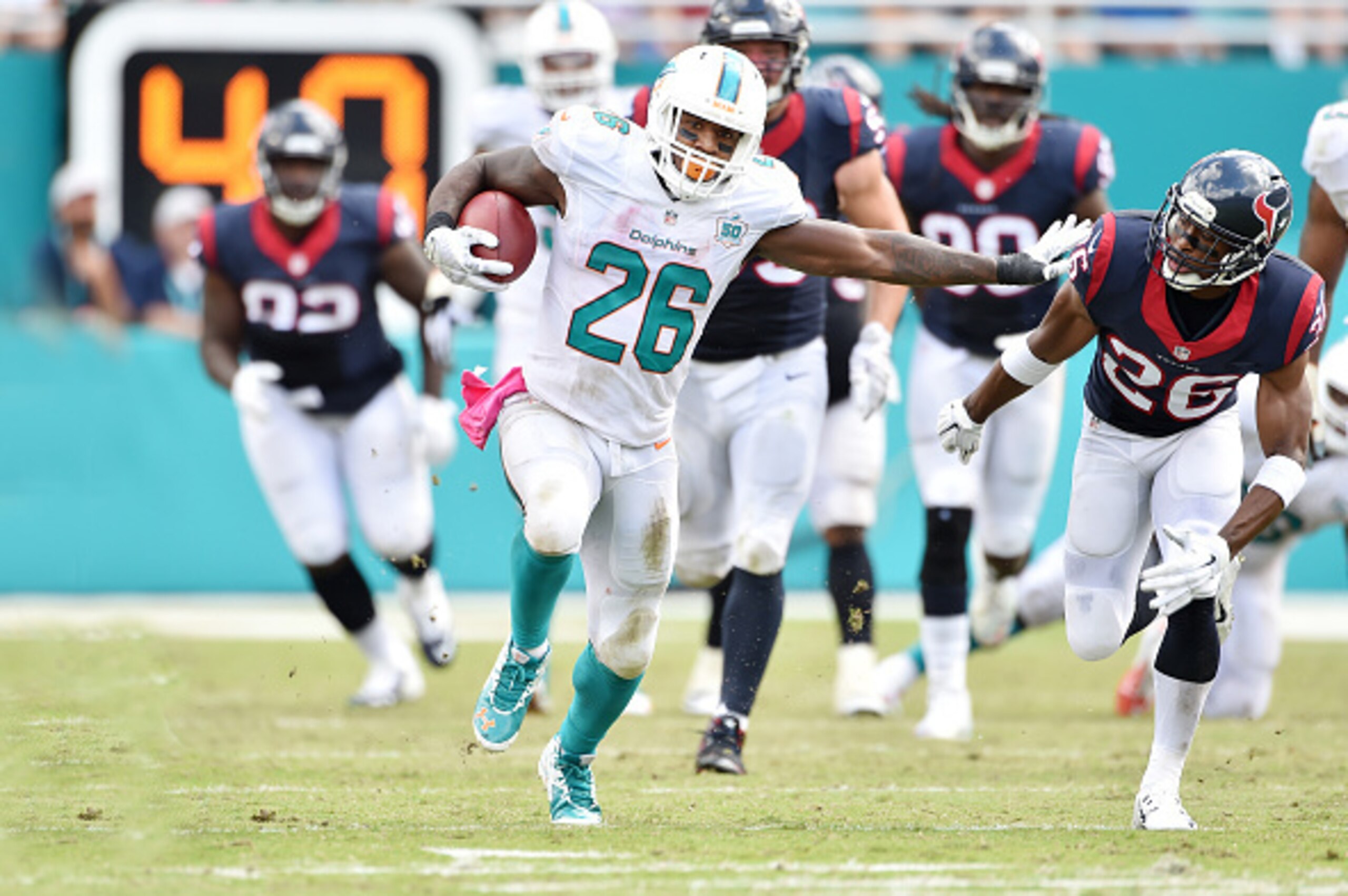 MIAMI GARDENS, FL - OCTOBER 25: Running back Lamar Miller #26 of the Miami Dolphins carries the ball during a NFL game against the Houston Texans at Sun Life Stadium on October 25, 2015 in Miami Gardens, Florida. (Photo by Ronald C. Modra/Sports Imagery MIAMI GARDENS, FL - OCTOBER 25: Running back Lamar Miller #26 of the Miami Dolphins carries the ball during a NFL game against the Houston Texans at Sun Life Stadium on October 25, 2015 in Miami Gardens, Florida. (Photo by Ronald C. Modra/Sports Imagery
