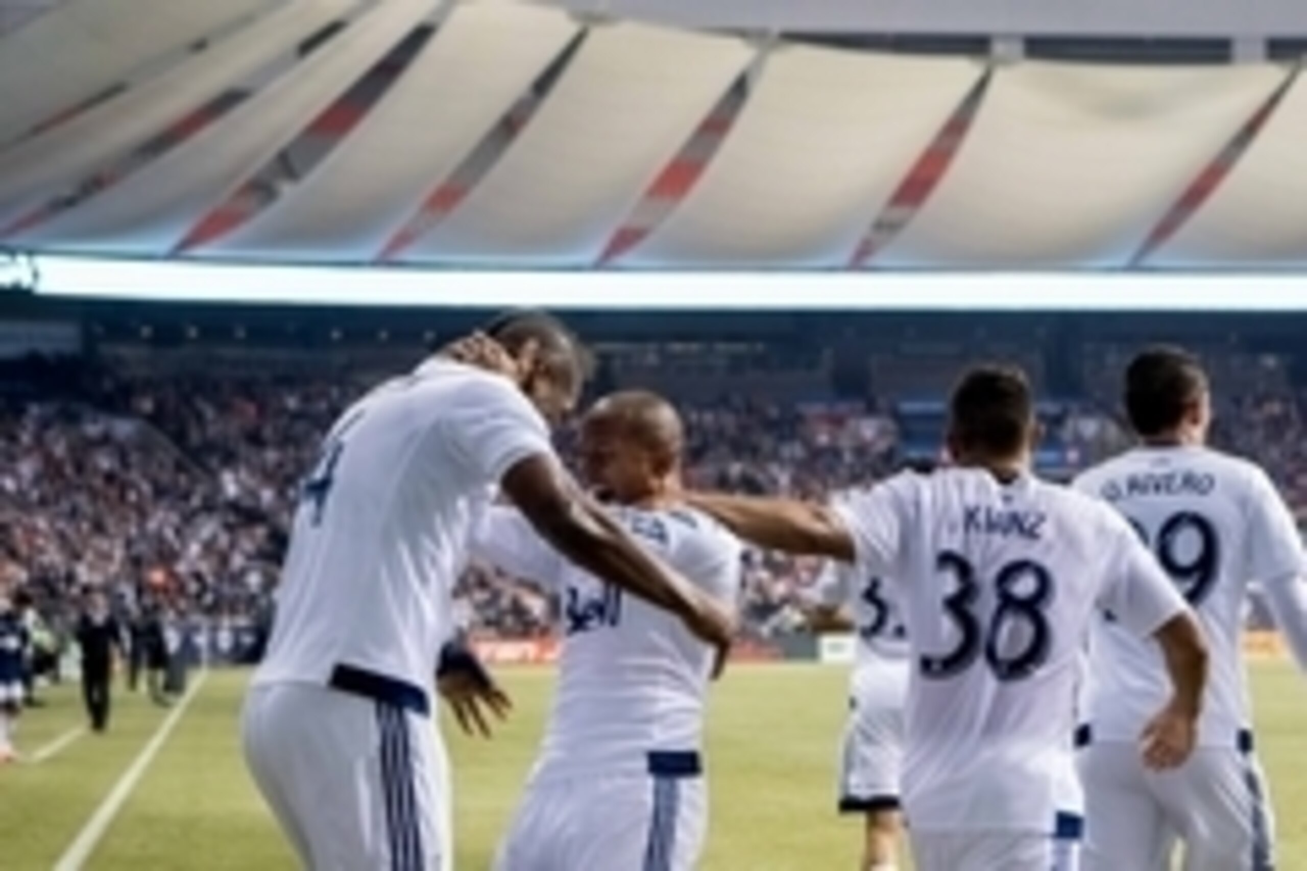 Mar 28, 2015; Vancouver, British Columbia, CAN; Vancouver Whitecaps FC defender Kendall Waston (4) and midfielder Robert Earnshaw (88) and defender Steven Beitashour (33) and midfielder Pedro Morales (77) and midfielder Kianz Froese (38) celebrate Earnsha