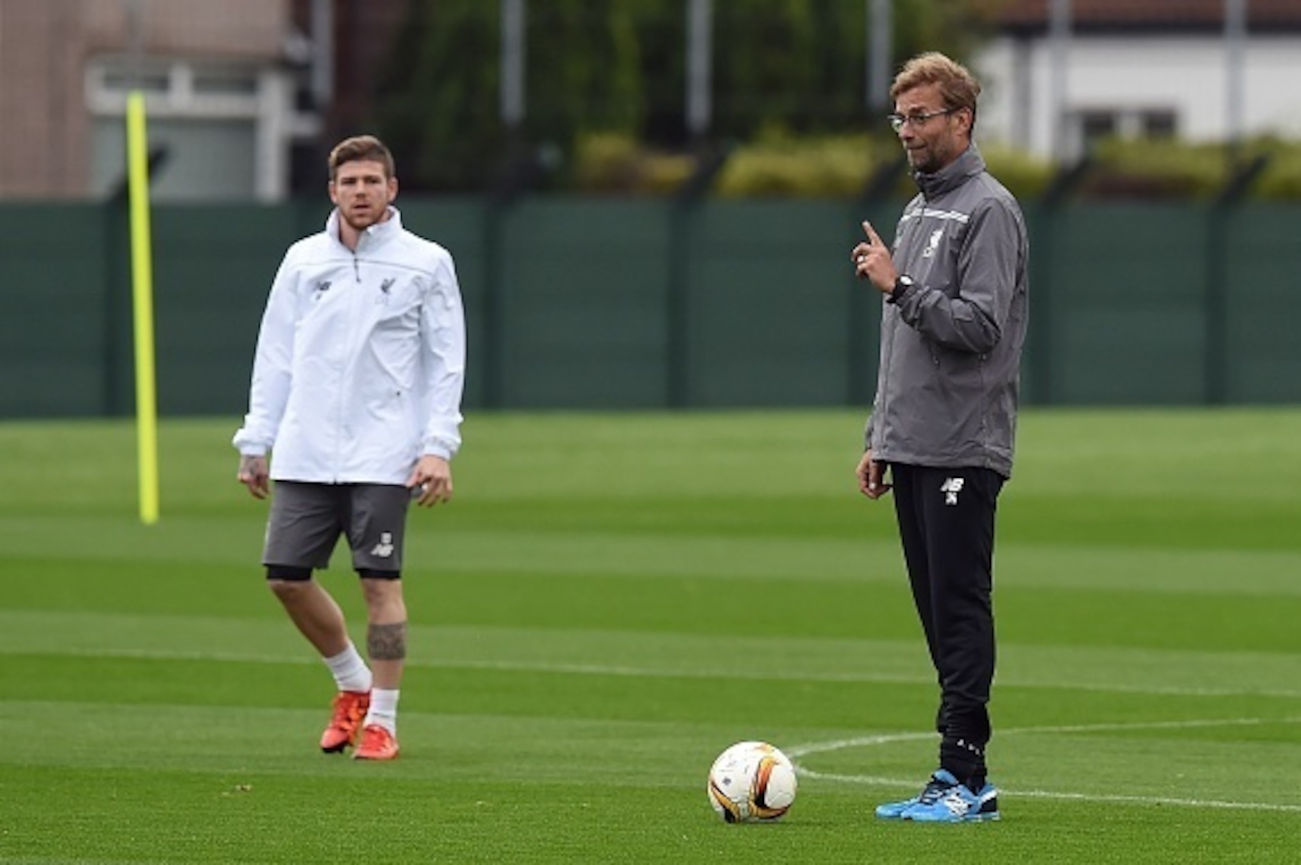 Liverpool's German manager Jurgen Klopp (R) gestures next to Liverpool's Spanish defender Alberto Moreno (L) during a team training session in Liverpool, northwest England, on October 21, 2015, on the eve of their UEFA Europa League group B football match