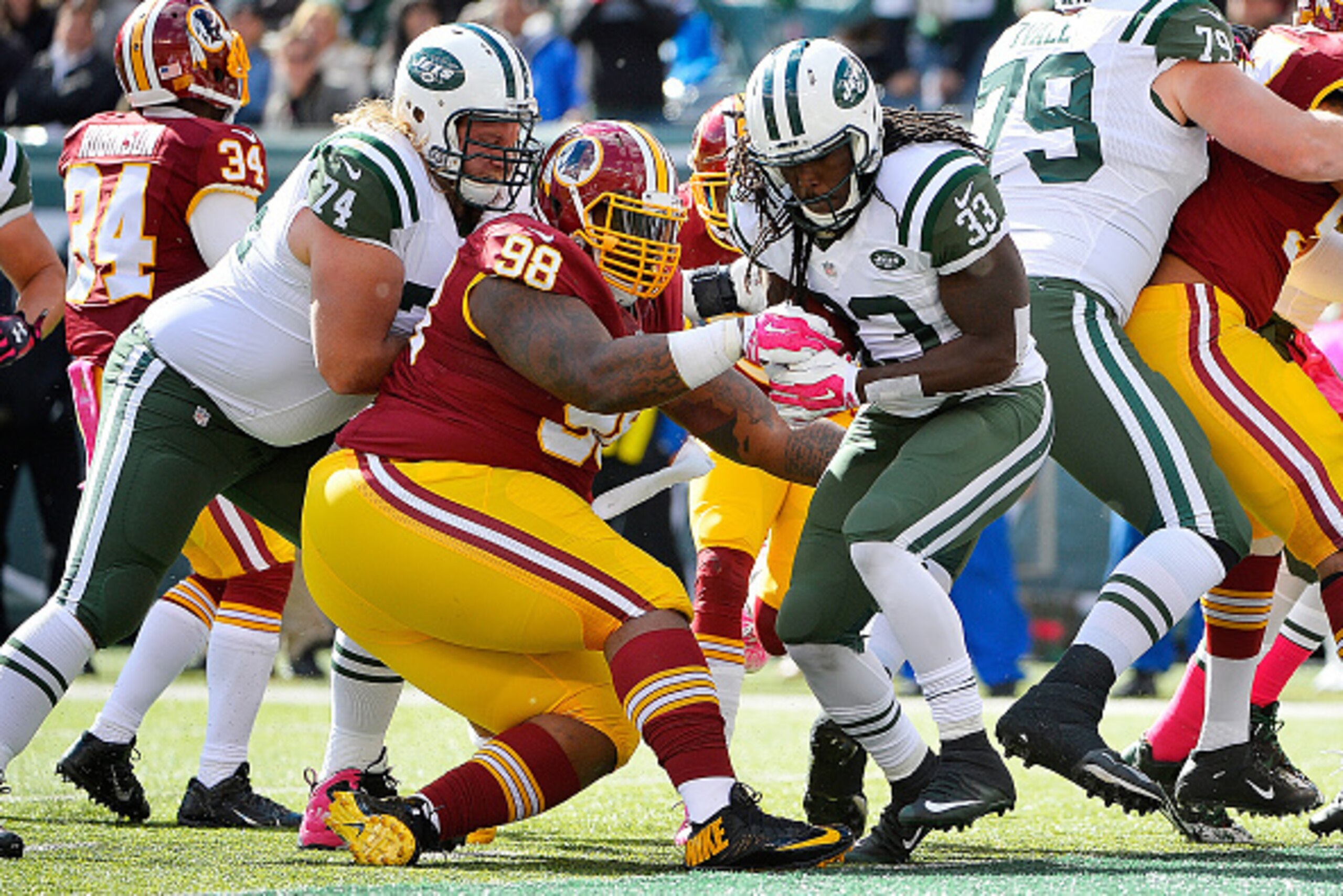 EAST RUTHERFORD, NJ - OCTOBER 18:  Chris Ivory #33 of the New York Jets escapes the tackle of Terrance Knighton #98 of the Washington Redskins and runs the ball for a first quarter touchdown at MetLife Stadium on October 18, 2015 in East Rutherford, New J