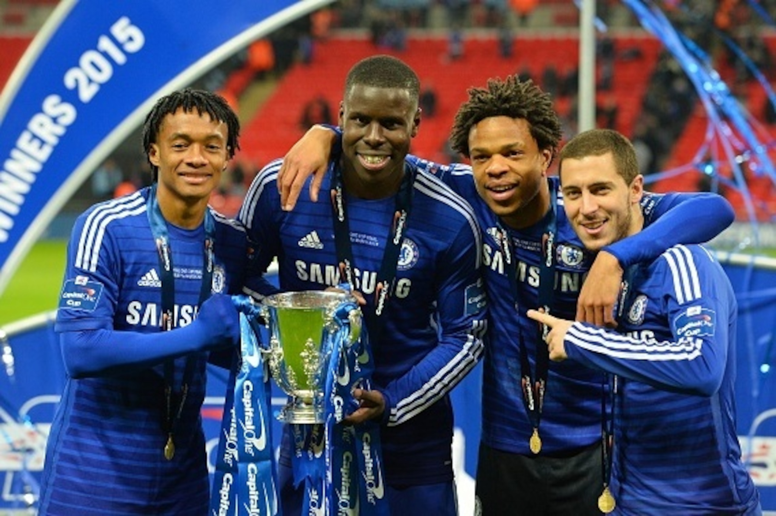Chelsea's Colombian midfielder Juan Cuadrado (L), Chelsea's French defender Kurt Zouma, Chelsea's French striker Loic Remy (2nd R) and Chelsea's Belgian midfielder Eden Hazard (R) celebrate with the trophy during the presentation after Chelsea won the Lea