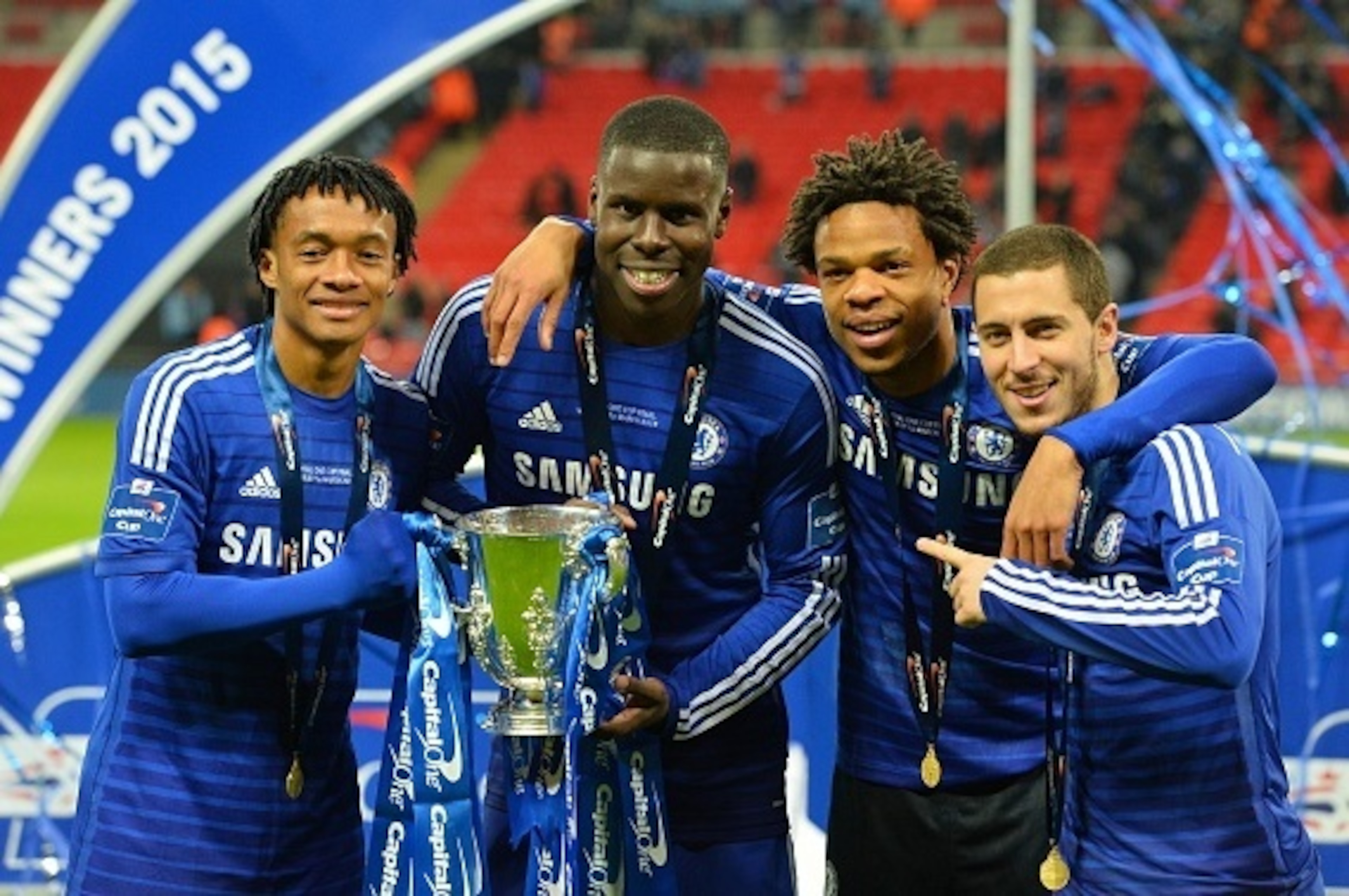 Chelsea's Colombian midfielder Juan Cuadrado (L), Chelsea's French defender Kurt Zouma, Chelsea's French striker Loic Remy (2nd R) and Chelsea's Belgian midfielder Eden Hazard (R) celebrate with the trophy during the presentation after Chelsea won the Lea Chelsea's Colombian midfielder Juan Cuadrado (L), Chelsea's French defender Kurt Zouma, Chelsea's French striker Loic Remy (2nd R) and Chelsea's Belgian midfielder Eden Hazard (R) celebrate with the trophy during the presentation after Chelsea won the Lea