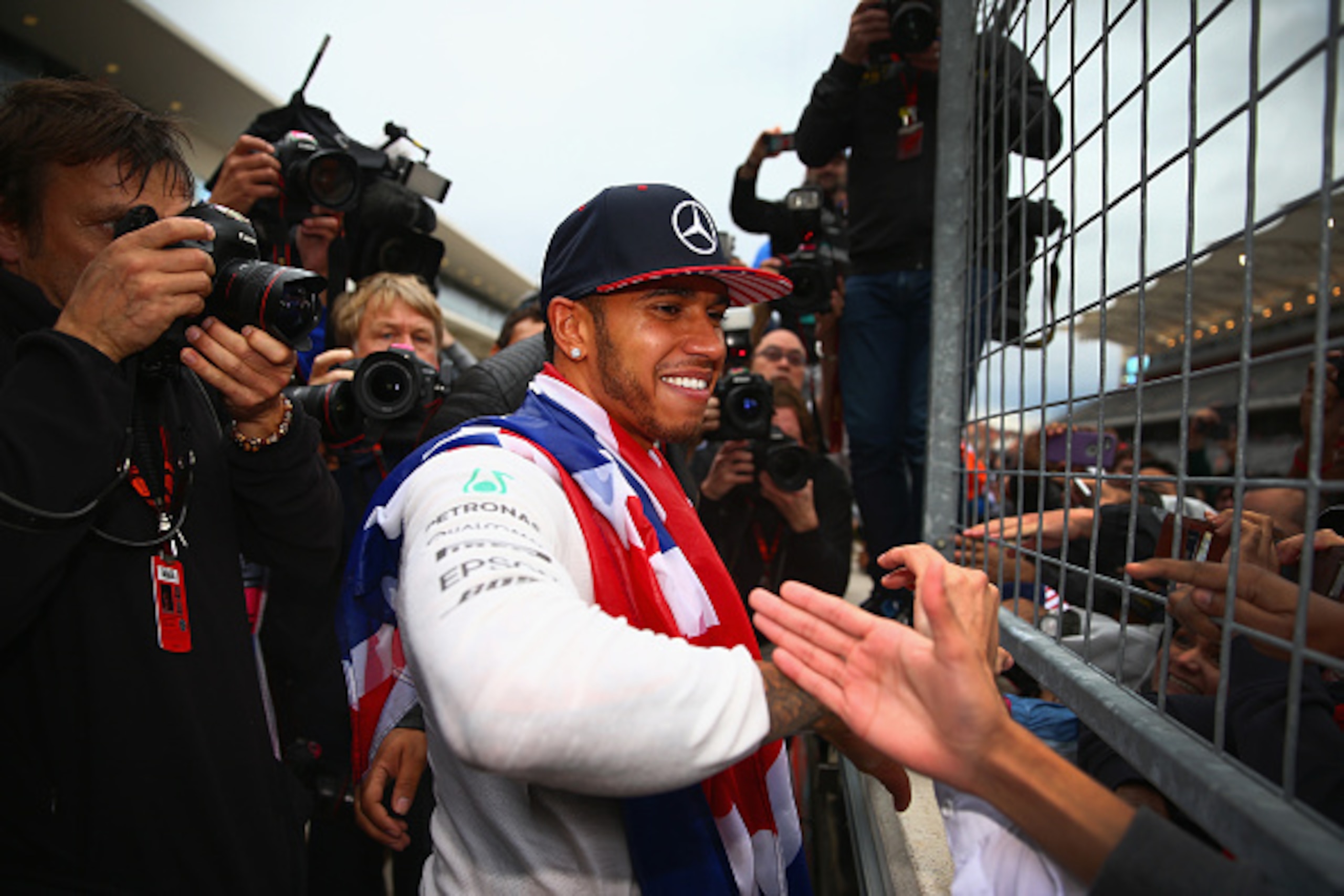 AUSTIN, TX - OCTOBER 25: Lewis Hamilton of Great Britain and Mercedes GP celebrates with fans waiting along the pit straight after winning the United States Formula One Grand Prix and the championship at Circuit of The Americas on October 25, 2015 in Aus AUSTIN, TX - OCTOBER 25: Lewis Hamilton of Great Britain and Mercedes GP celebrates with fans waiting along the pit straight after winning the United States Formula One Grand Prix and the championship at Circuit of The Americas on October 25, 2015 in Aus