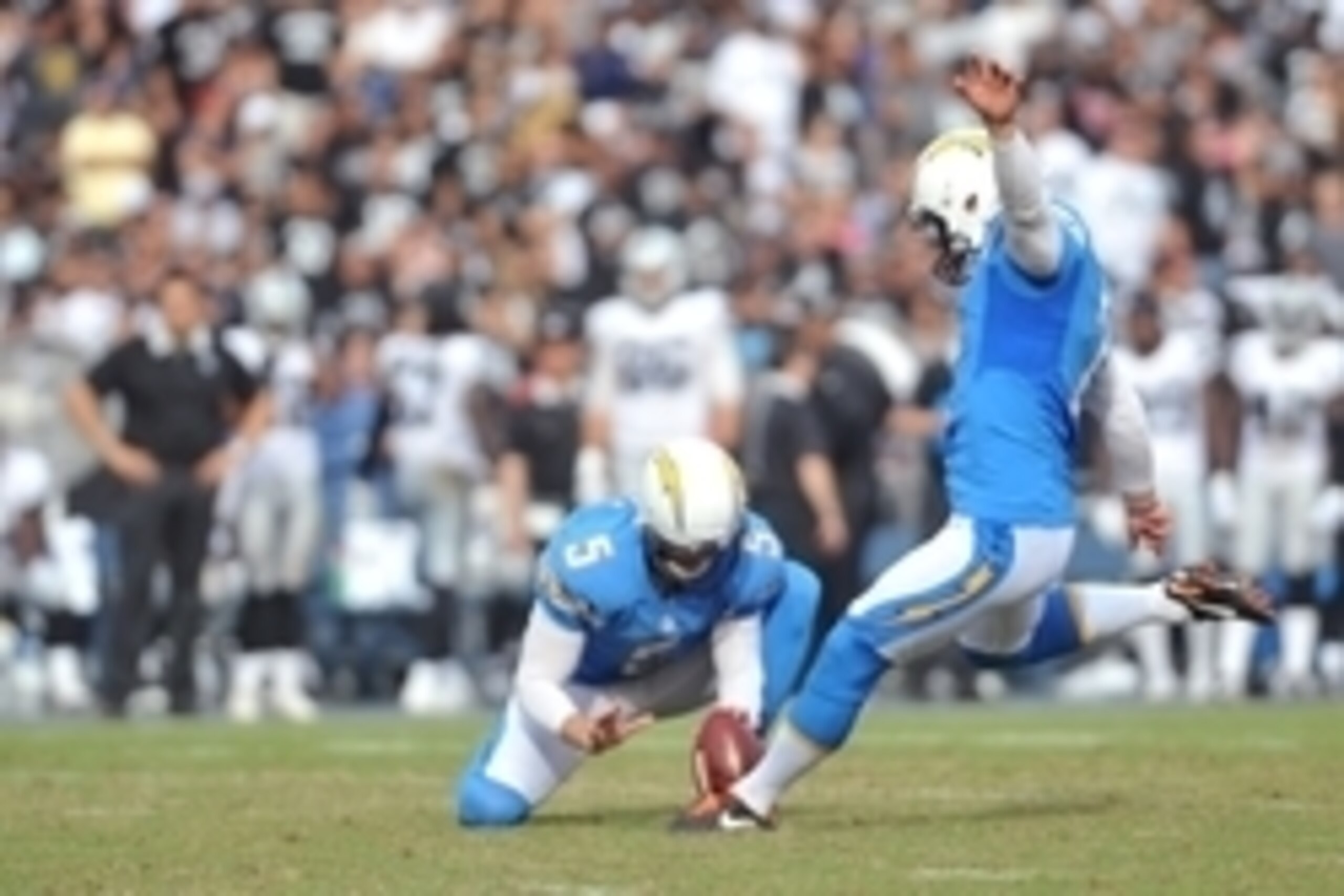 Oct 25, 2015; San Diego, CA, USA; San Diego Chargers kicker Josh Lambo (2) kicks while punter Mike Scifres (5) holds during the second half of the game against the Oakland Raiders at Qualcomm Stadium. Oakland won 37-29. Mandatory Credit: Orlando Ramirez-U