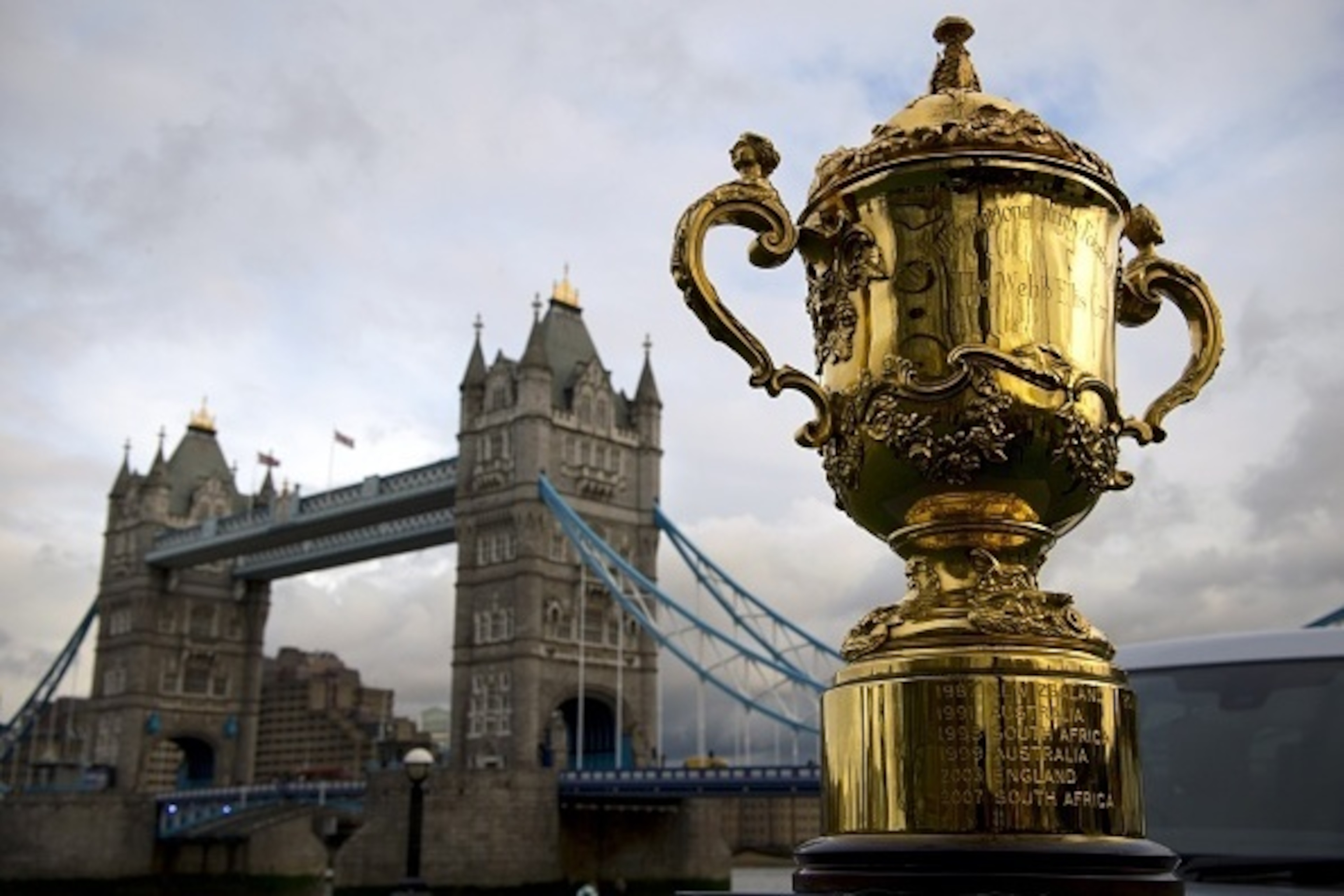 The Webb Ellis Cup, is displayed close to Tower Bridge ahead of the Rugby World Cup draw in London on December 3, 2012. Teams in the top three bands are to be drawn for the England 2015 tournament. There will be four pools of five teams to compete at the 