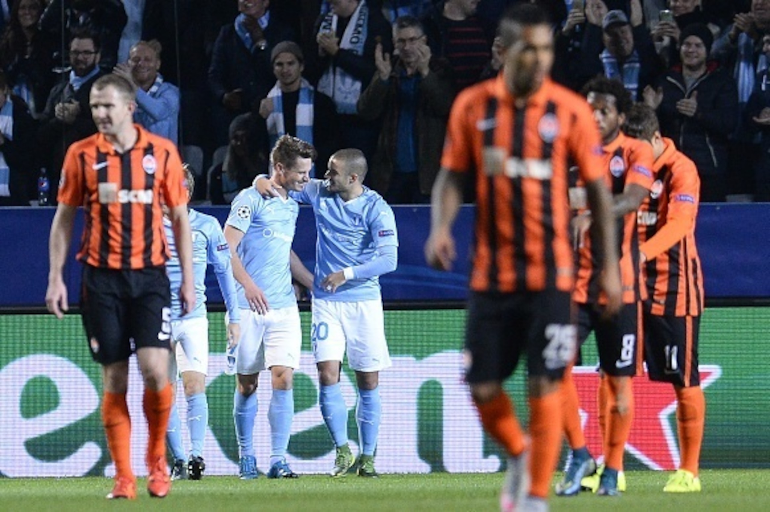 Malmo's Swedish forward Markus Rosenberg (2nd L) celebrates with his teammate Serbian midfielder Vladimir Rodic after scoring the opening goal during the UEFA Champions League Group A, first-leg football match between Malmo FF and FC Shakhtar Donetsk in M