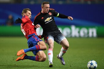 KHIMKI, RUSSIA - OCTOBER 21: Aleksei Berezutski (L) of CSKA Moscow in action against Wayne Rooney of Manchester United FC during the UEFA Champions League Group B match between CSKA Moscow and Manchester United FC at the Arena Khimki Stadium on October 21