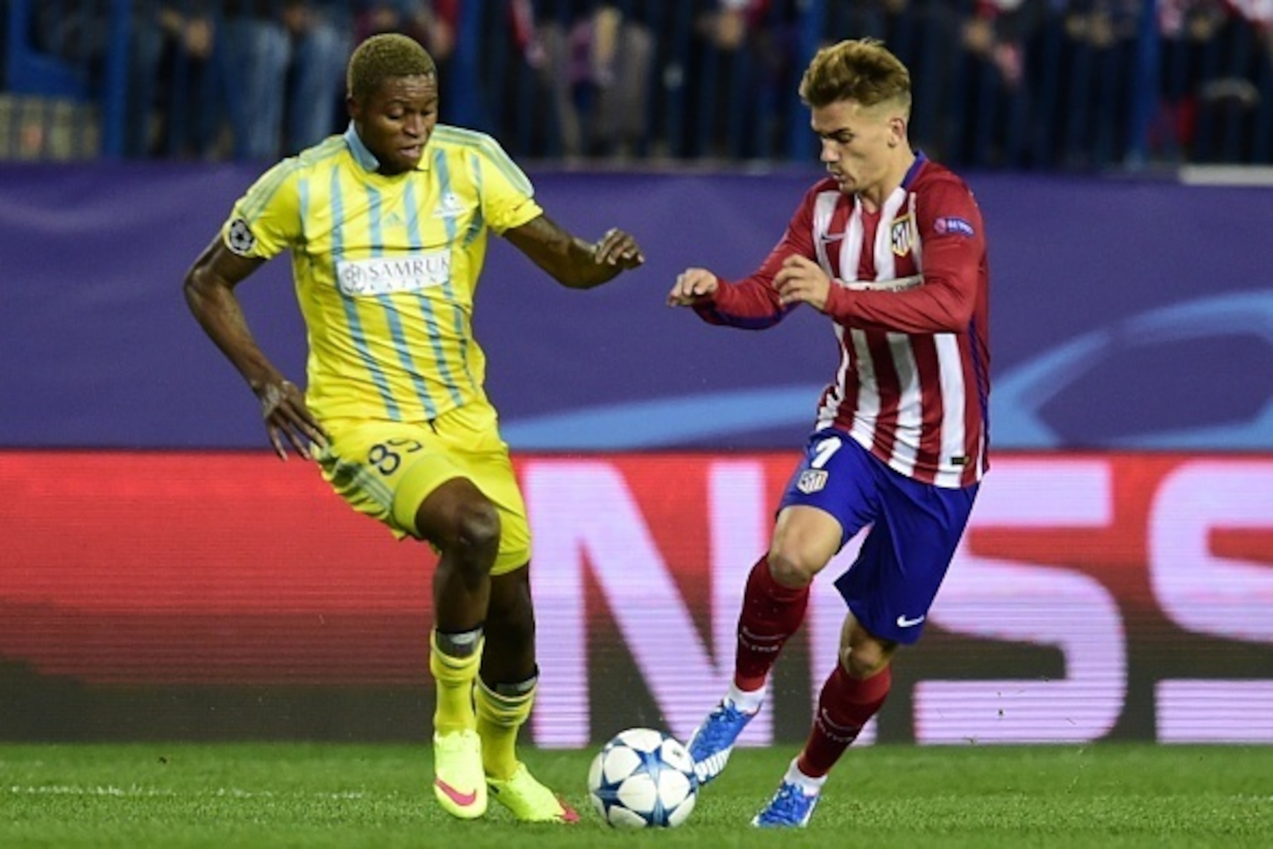 Astana's Congolese forward Junior Kabananga (L) vies with Atletico Madrid's French forward Antoine Griezmann during the UEFA Champions League group C football match Club Atletico de Madrid vs FC Astana at the Vicente Calderon stadium in Madrid on October 