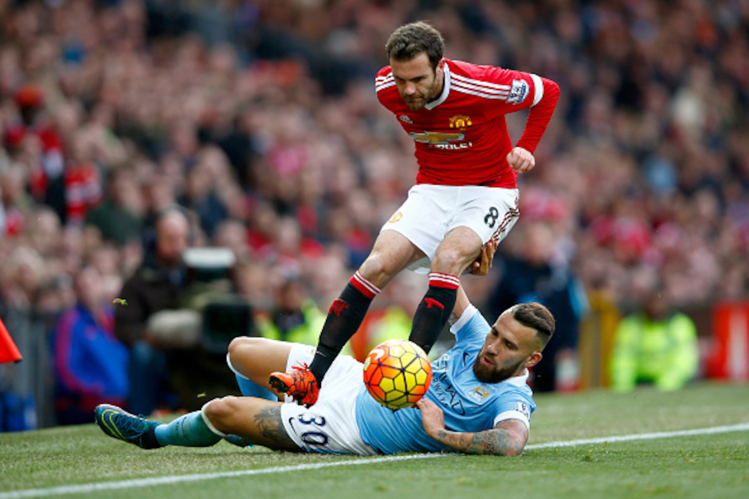 MANCHESTER, ENGLAND - OCTOBER 25:  Juan Mata of Manchester United is tackled by Nicolas Otamendi of Manchester City during the Barclays Premier League match between Manchester United and Manchester City at Old Trafford on October 25, 2015 in Manchester, E