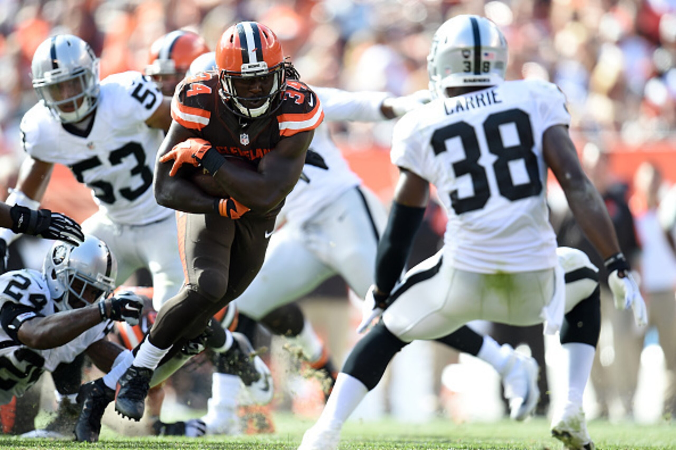 CLEVELAND, OH - SEPTEMBER 27:  Isaiah Crowell #34 of the Cleveland Browns runs for a first down in front of T.J. Carrie #38 of the Oakland Raiders during the fourth quarter at FirstEnergy Stadium on September 27, 2015 in Cleveland, Ohio.  (Photo by Jason 