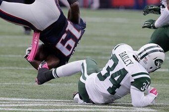 Dion Bailey tackles Patriots wideout Brandon LaFell.