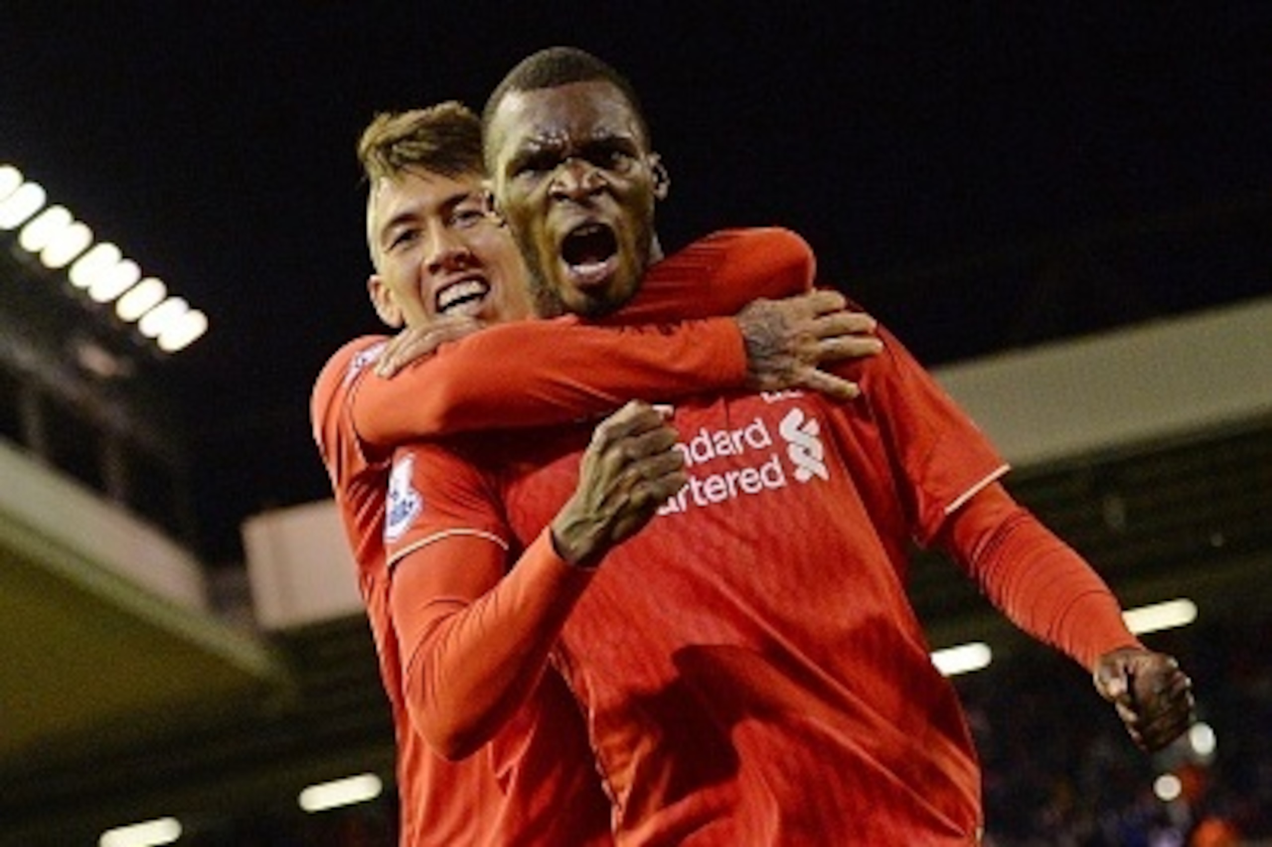 Liverpool's Zaire-born Belgian striker Christian Benteke celebrates with Liverpool's Brazilian midfielder Roberto Firmino (L) after scoring the opening goal of the English Premier League football match between Liverpool and Southampton at Anfield stadium 