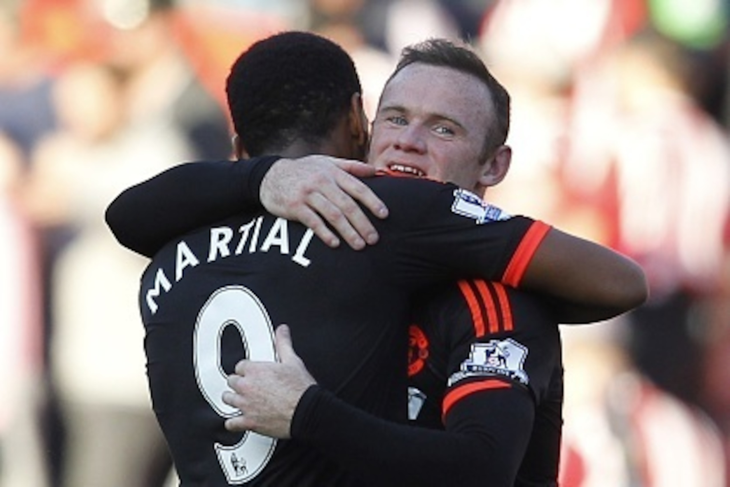 Manchester United's English striker Wayne Rooney embraces Manchester United's French striker Anthony Martial (L) after the English Premier League football match between Southampton and Manchester United at St Mary's Stadium in Southampton, southern Englan