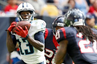 HOUSTON, TX - NOVEMBER 30: Kendall Wright #13 of the Tennessee Titans catches a touchdown pass while Kendrick Lewis #21 of the Houston Texans defends in the third quarter in a NFL game on November 30, 2014 at NRG Stadium in Houston, Texas. (Photo by Bob L