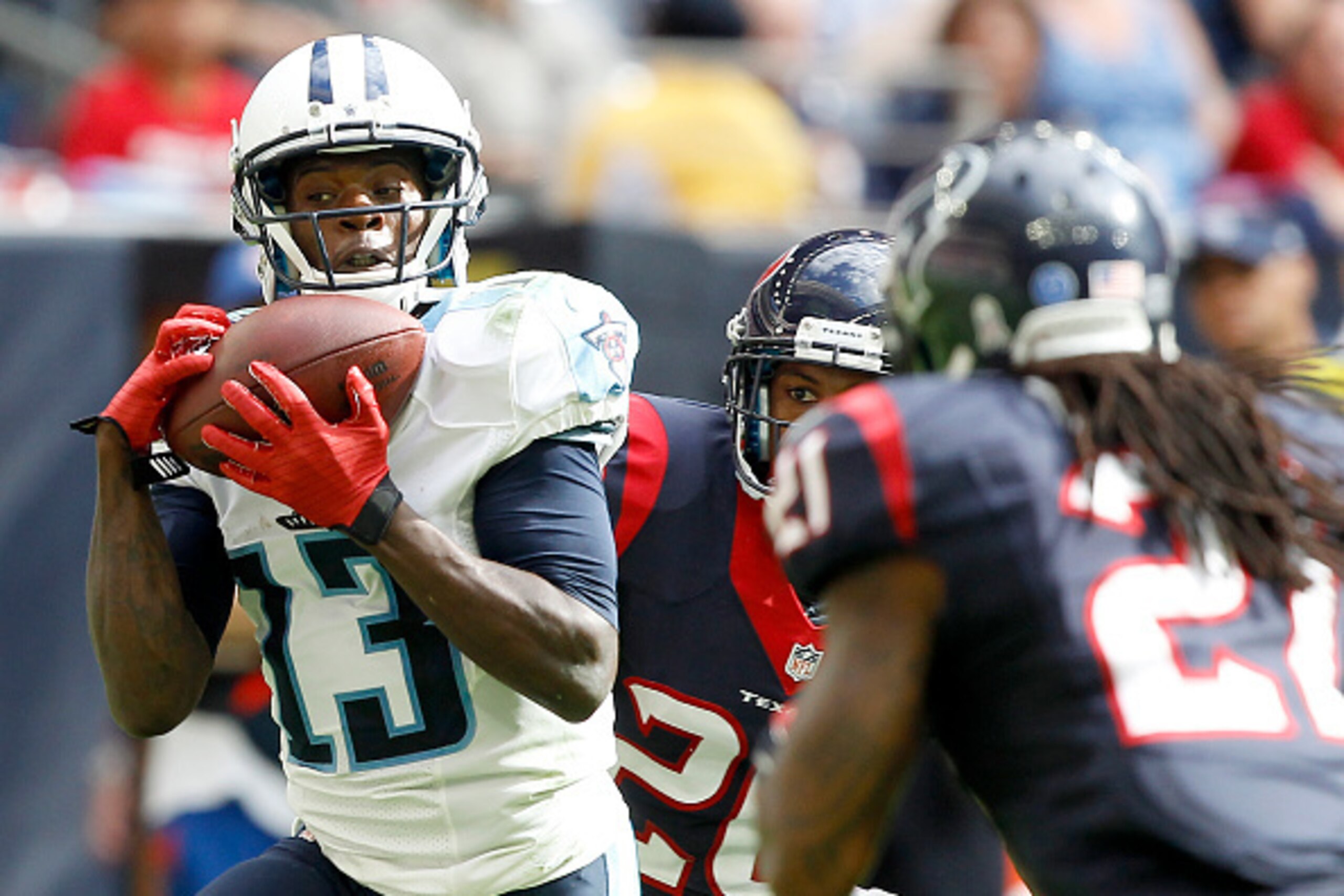 HOUSTON, TX - NOVEMBER 30: Kendall Wright #13 of the Tennessee Titans catches a touchdown pass while Kendrick Lewis #21 of the Houston Texans defends in the third quarter in a NFL game on November 30, 2014 at NRG Stadium in Houston, Texas. (Photo by Bob L HOUSTON, TX - NOVEMBER 30: Kendall Wright #13 of the Tennessee Titans catches a touchdown pass while Kendrick Lewis #21 of the Houston Texans defends in the third quarter in a NFL game on November 30, 2014 at NRG Stadium in Houston, Texas. (Photo by Bob L