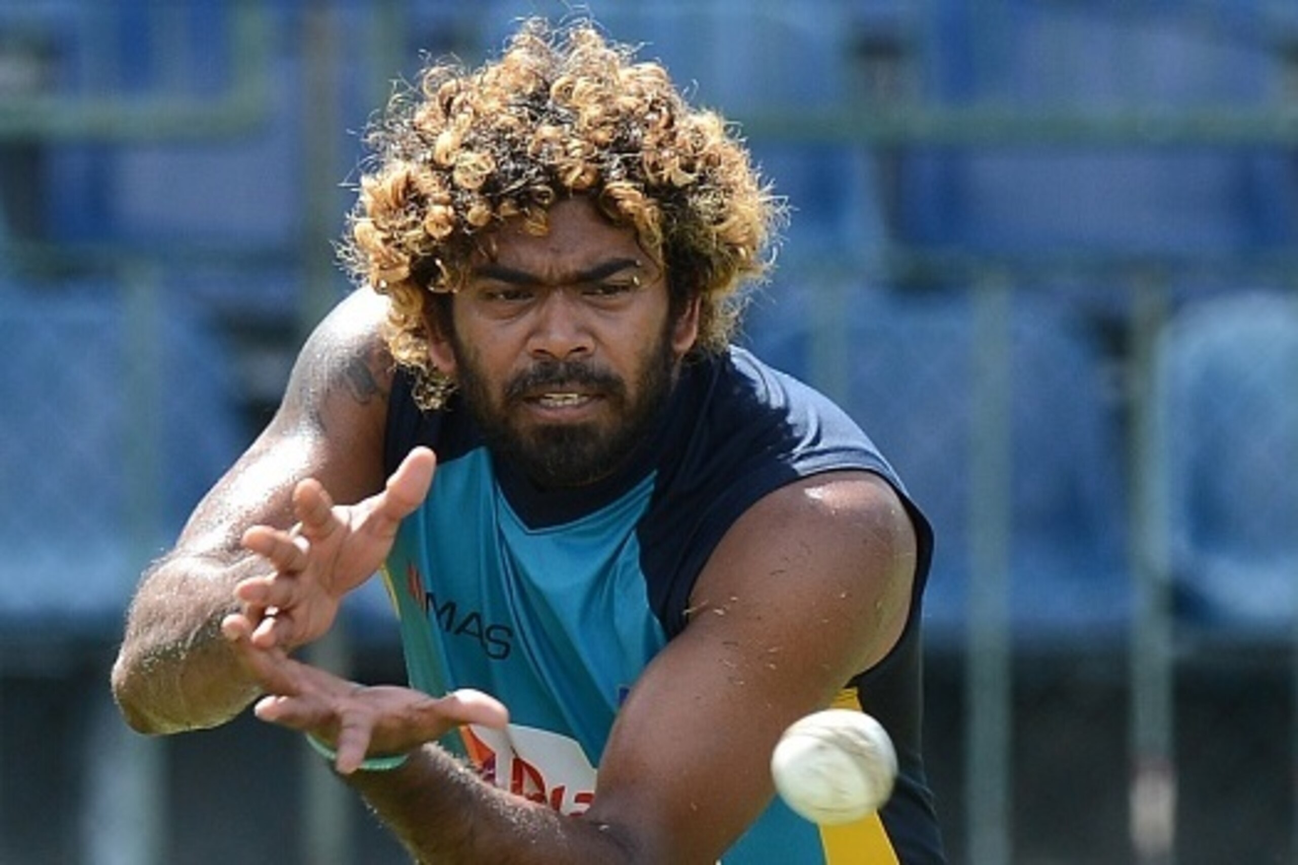 Sri Lankan cricketer Lasith Malinga catches a ball during a practice session at the R. Premadasa Stadium in Colombo on October 31, 2015 ahead of the opening One-Day International (ODI) cricket match between Sri Lanka and the West Indies on November 1. The