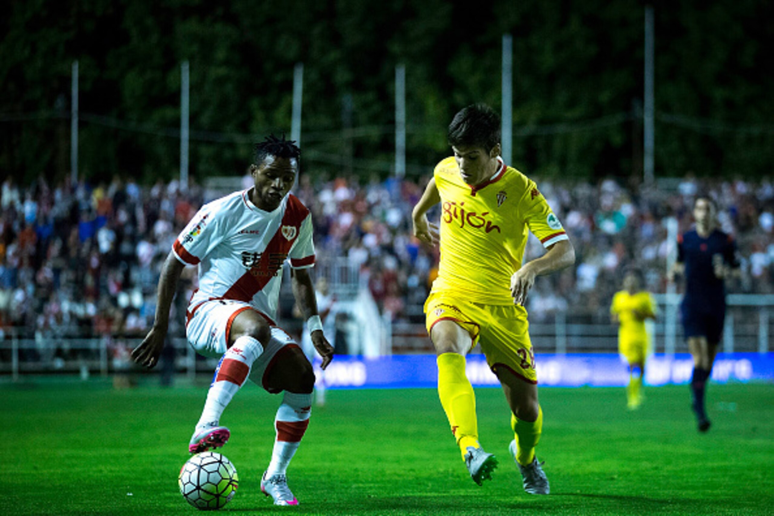 MADRID, SPAIN - SEPTEMBER 23: Lassane Bangoura alias Lass B. (L) of Rayo Vallecano de Madrid competes for the ball with Jorge Mere (R) of Real Sporting de Gijon during the La Liga match between Rayo Vallecano de Madrid and Real Sporting de Gijon at Estadi