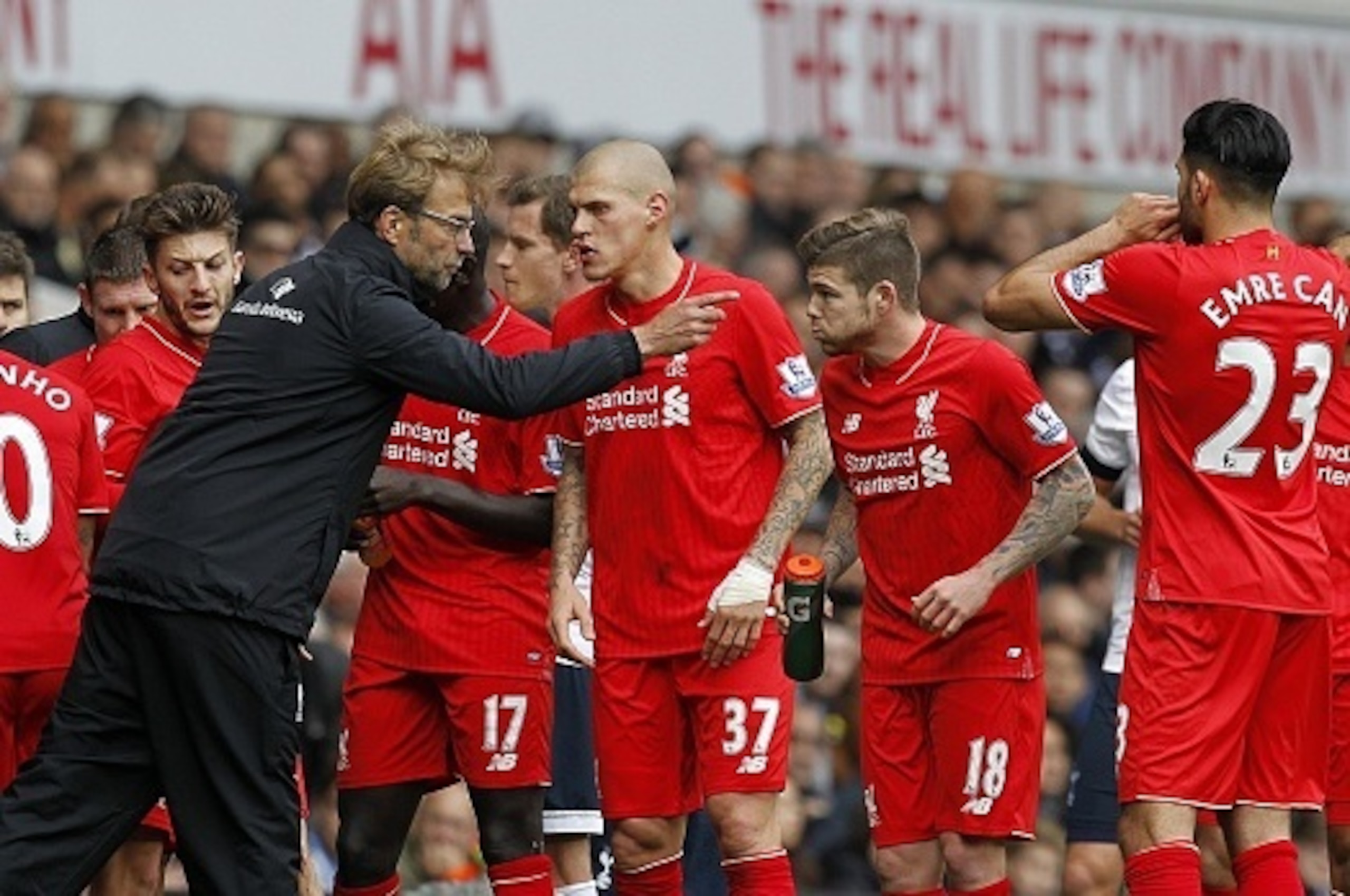 Liverpool's German manager Jurgen Klopp talks to his players during a break in play during the English Premier League football match between Tottenham Hotspur and Liverpool at White Hart Lane in north London on October 17, 2015. AFP PHOTO / IAN KINGTON

R