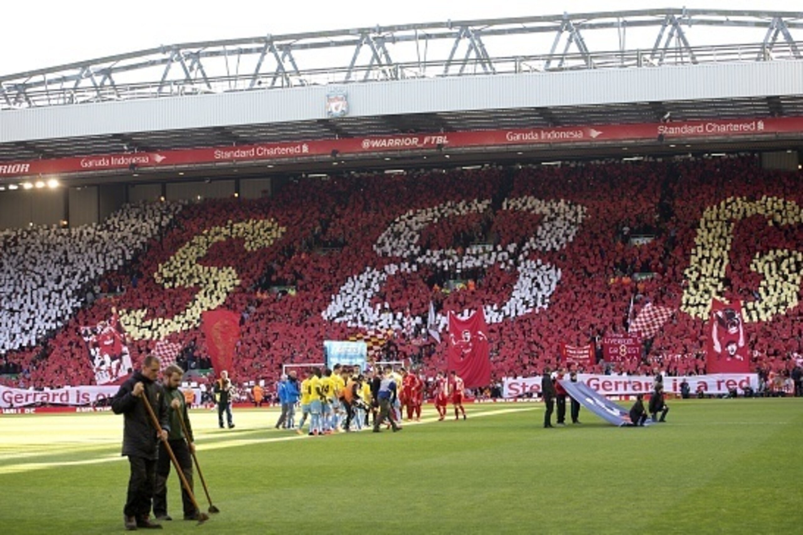 Liverpool fans hold coloured cards to spell 'S 8 G' to honour Liverpool's English midfielder Steven Gerrard ahead of the English Premier League football match between Liverpool and Crystal Palace at the Anfield stadium in Liverpool, northwest England, on 