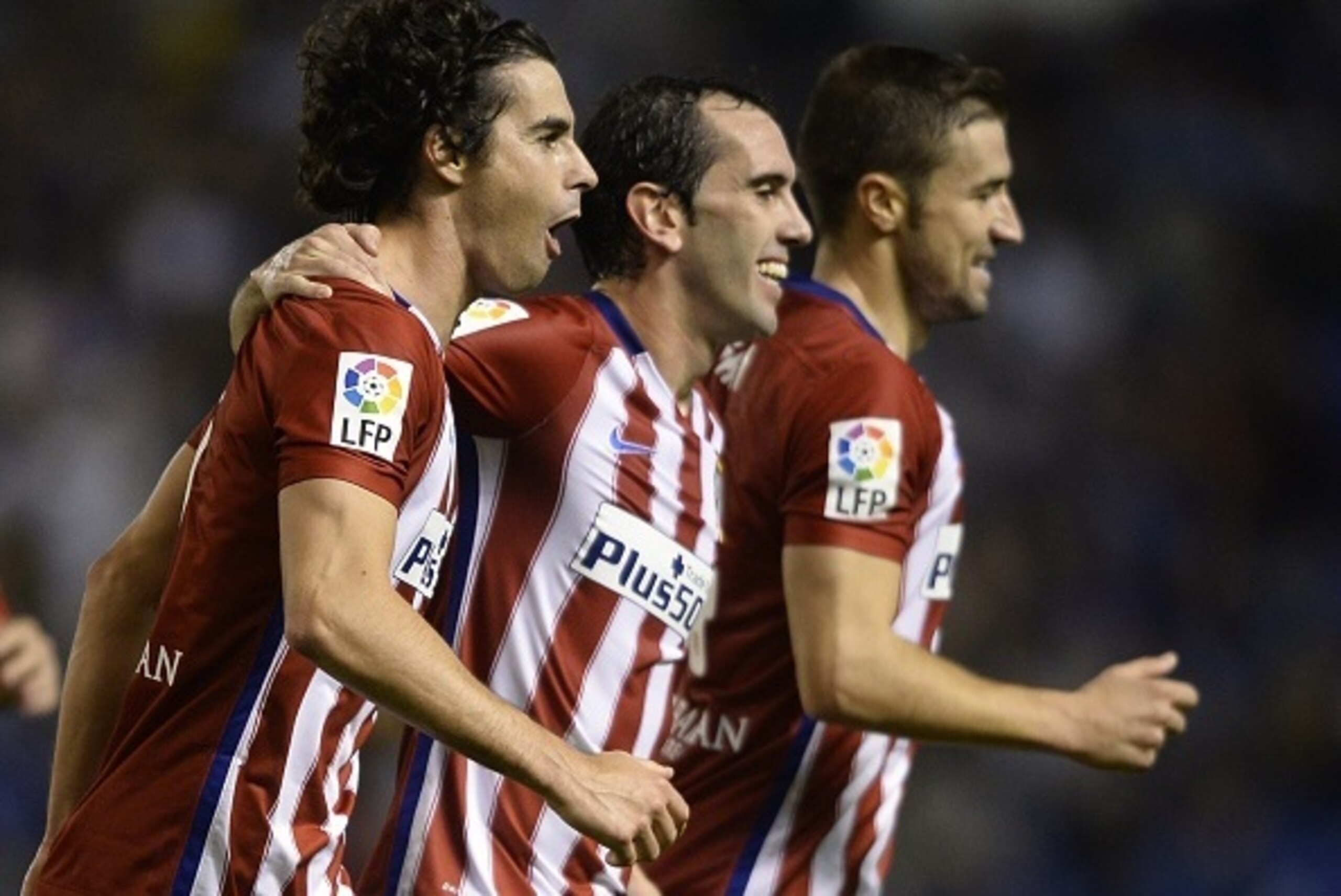 (LtoR)  Atletico Madrid's Portuguese midfielder Tiago celebrates with teammates Uruguayan defender Diego Godin and  midfielder Gabi after scoring a goal during the Spanish league football match RC Deportivo La Coruna vs Club Atletico de Madrid at the Muni