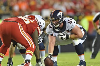 KANSAS CITY, MO - SEPTEMBER 17:  Center Matt Paradis #61 of the Denver Broncos gets ready to snap the ball against the Kansas City Chiefs during the first half at Arrowhead Stadium on September 17, 2015 in Kansas City, Missouri.  (Photo by Peter G. Aiken/