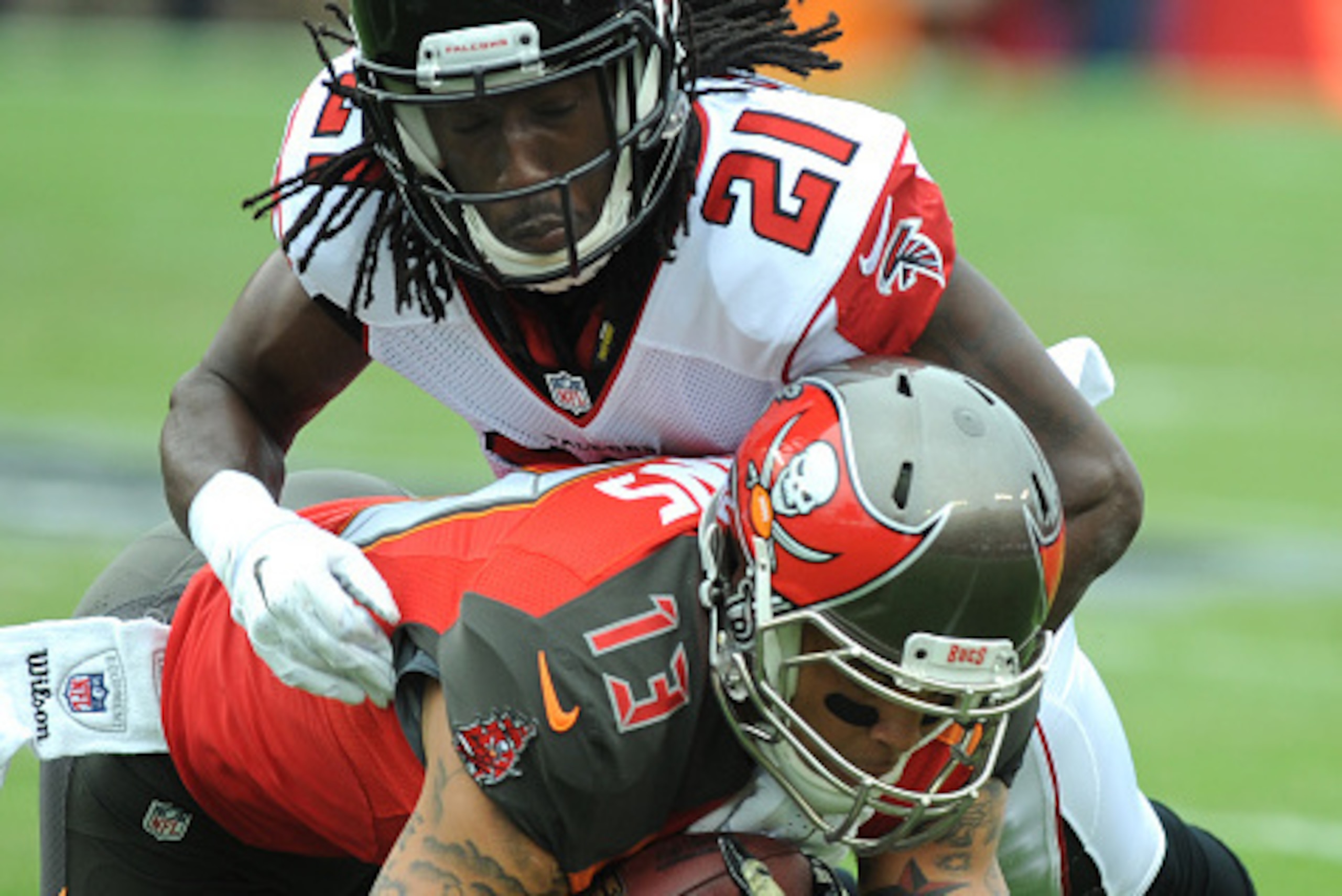 TAMPA, FL - NOVEMBER 9:   Wide receiver Mike Evans #13 of the Tampa Bay Buccaneers is tackled by cornerback Desmond Trufant #21 of the Atlanta Falcons at Raymond James Stadium on November 9, 2014 in Tampa, Florida. (Photo by Cliff McBride/Getty Images)