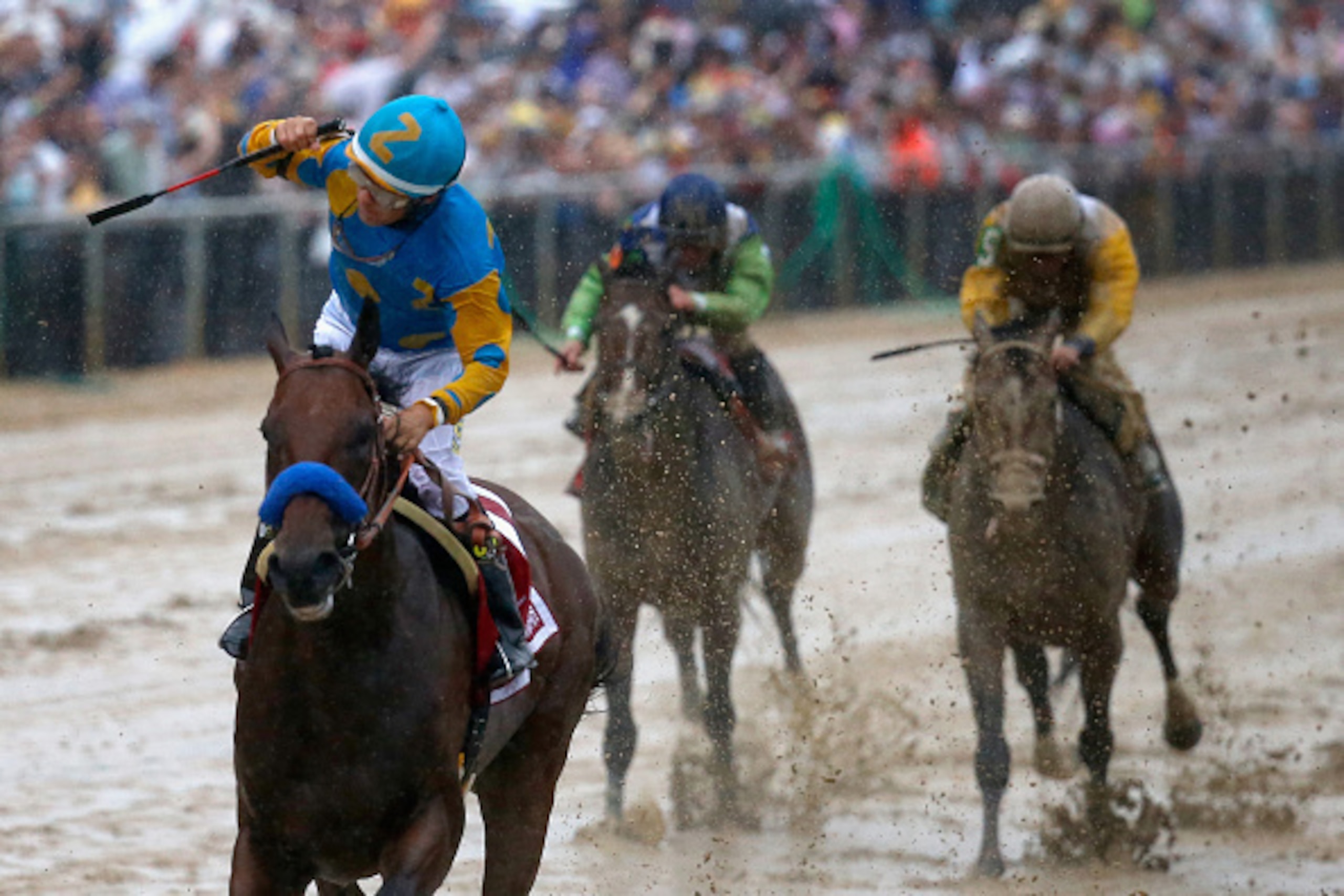 BALTIMORE, MD - MAY 16:  Jockey Victor Espinoza celebrates aboard American Pharoah #1 after crossing the finish line to win the 140th running of the Preakness Stakes at Pimlico Race Course on May 16, 2015 in Baltimore, Maryland.  (Photo by Rob Carr/Getty 
