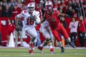 Oct 24, 2015; Piscataway, NJ, USA;  Ohio State Buckeyes quarterback J.T. Barrett (16) turns up field during the first quarter against the Rutgers Scarlet Knights at High Points Solutions Stadium. Mandatory Credit: Jim O'Connor-USA TODAY Sports