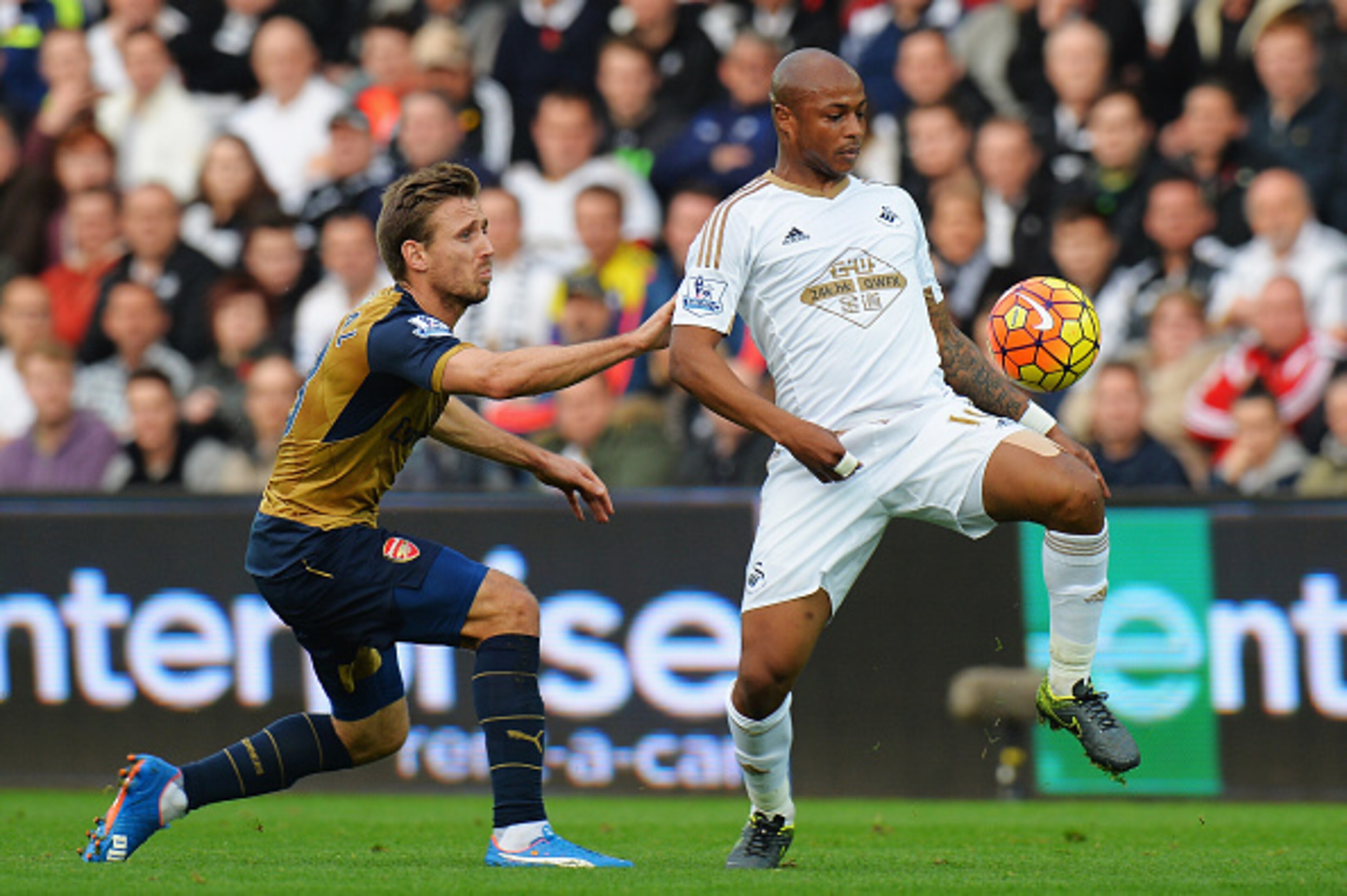 SWANSEA, WALES - OCTOBER 31: Andre Ayew of Swansea City is challenged by Nacho Monreal of Arsenal during the Barclays Premier League match between Swansea City and Arsenal at Liberty Stadium on October 31, 2015 in Swansea, Wales. (Photo by Tony Marshall/ SWANSEA, WALES - OCTOBER 31: Andre Ayew of Swansea City is challenged by Nacho Monreal of Arsenal during the Barclays Premier League match between Swansea City and Arsenal at Liberty Stadium on October 31, 2015 in Swansea, Wales. (Photo by Tony Marshall/