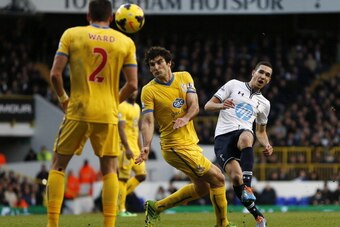 Tottenham Hotspur's French midfielder Nabil Bentaleb (R) curls a shot past Crystal Palace's Australian midfielder Mile Jedinak (C) during the English Premier League football match between Tottenham Hotspur and Crystal Palace at White Hart Lane in north Lo