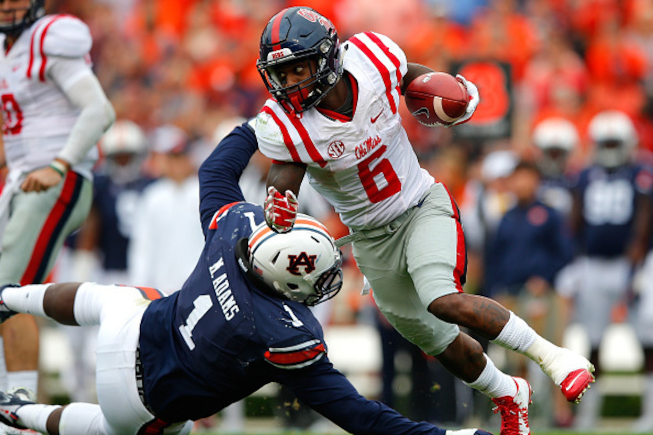 AUBURN, AL - OCTOBER 31:  Jaylen Walton #6 of the Mississippi Rebels breaks a tackle by Montravius Adams #1 of the Auburn Tigers at Jordan-Hare Stadium on October 31, 2015 in Auburn, Alabama.  (Photo by Kevin C. Cox/Getty Images)
