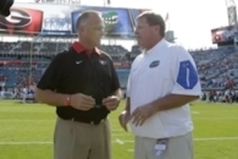Oct 31, 2015; Jacksonville, FL, USA; Georgia Bulldogs head coach Mark Richt and Florida Gators head coach Jim McElwain talk prior to the game at  EverBank Stadium. Mandatory Credit: Kim Klement-USA TODAY Sports