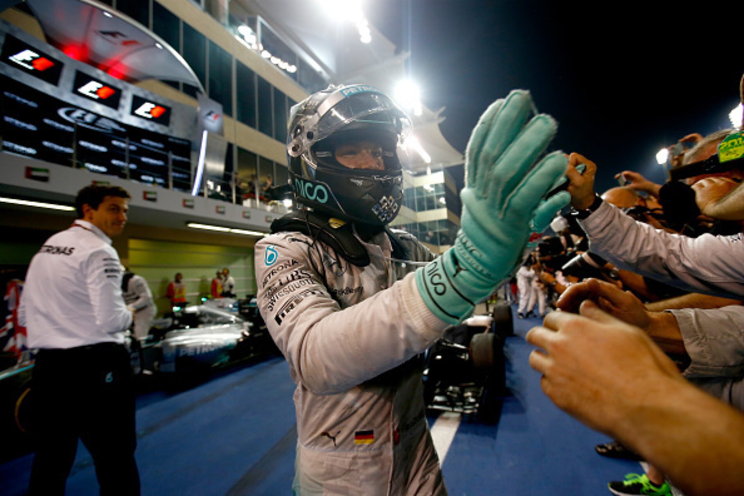 ABU DHABI, UNITED ARAB EMIRATES - NOVEMBER 23:  Nico Rosberg of Germany and Mercedes GP shakes hands with members of his team after the Abu Dhabi Formula One Grand Prix at Yas Marina Circuit on November 23, 2014 in Abu Dhabi, United Arab Emirates.  (Photo