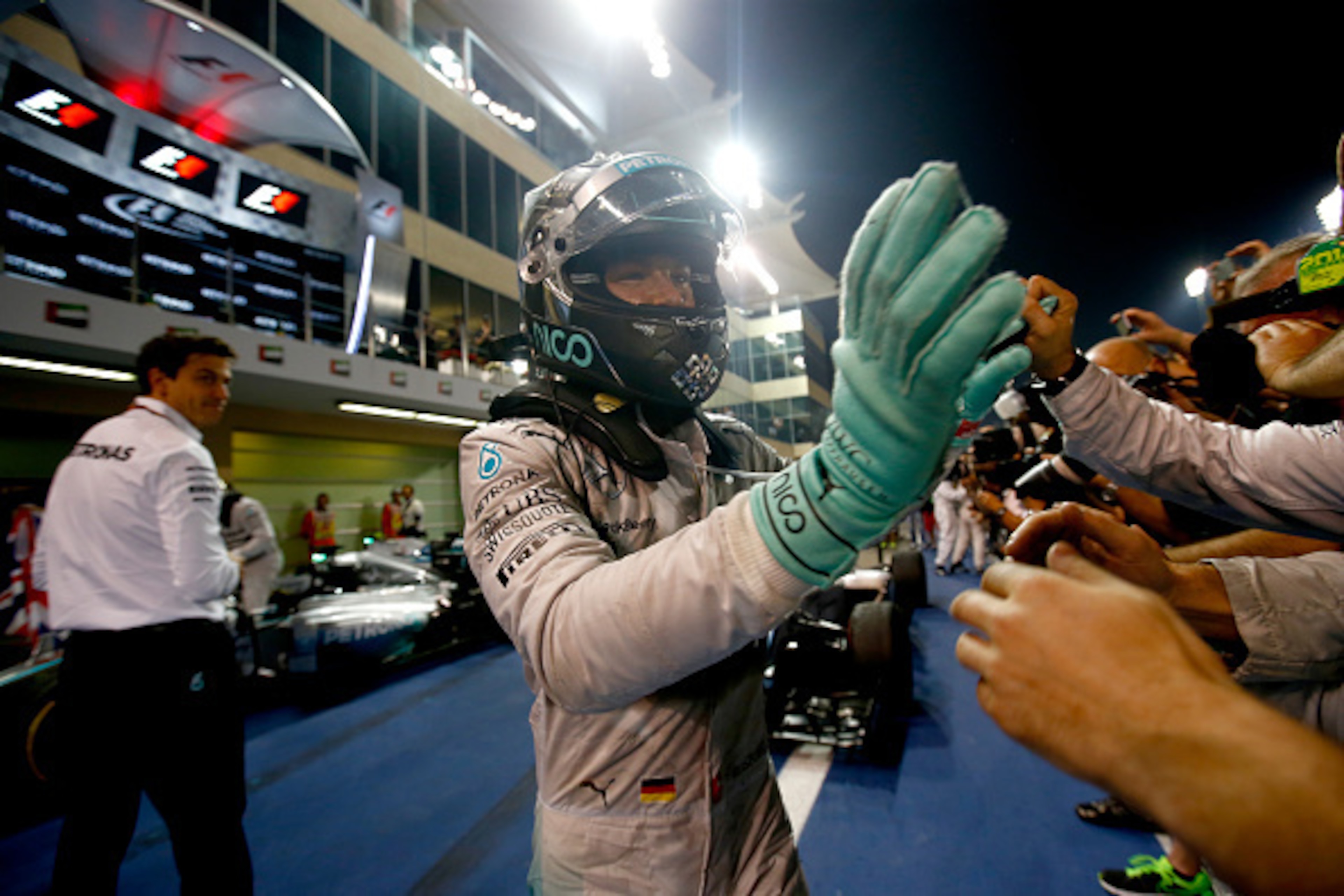 ABU DHABI, UNITED ARAB EMIRATES - NOVEMBER 23:  Nico Rosberg of Germany and Mercedes GP shakes hands with members of his team after the Abu Dhabi Formula One Grand Prix at Yas Marina Circuit on November 23, 2014 in Abu Dhabi, United Arab Emirates.  (Photo