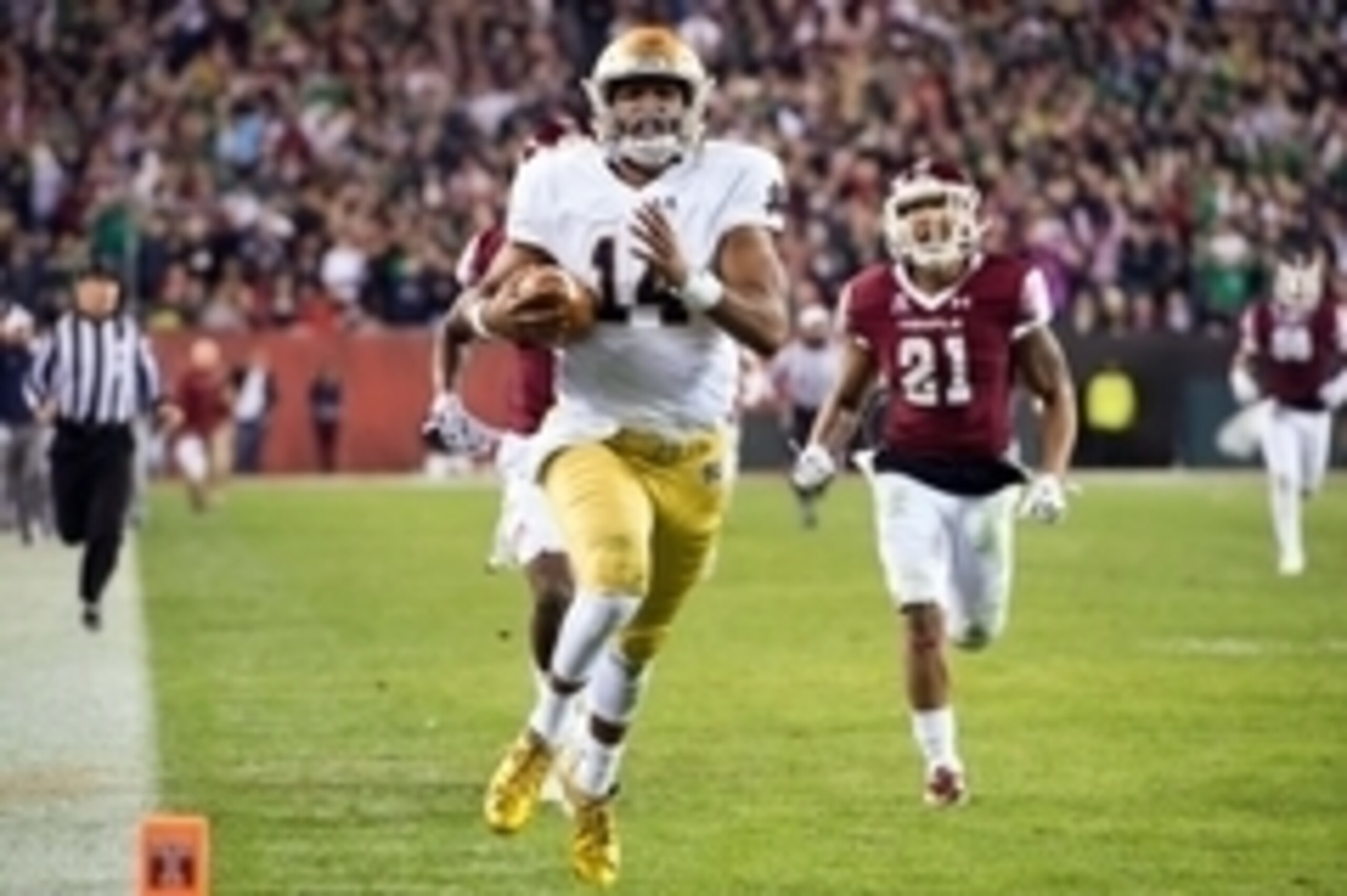 Oct 31, 2015; Philadelphia, PA, USA; Notre Dame Fighting Irish quarterback DeShone Kizer (14) runs for a touchdown as Temple Owls safety Alex Wells (21) pursues in the second quarter at Lincoln Financial Field. Mandatory Credit: Matt Cashore-USA TODAY Spo